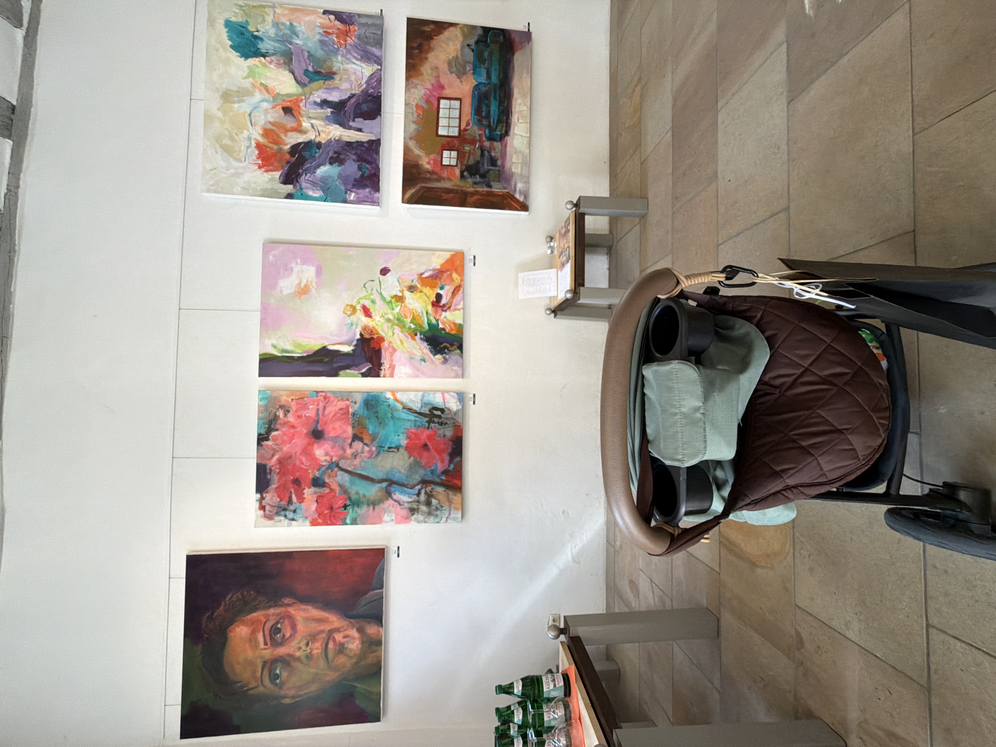 Art exhibition displayed alongside stroller in Meisenheim building