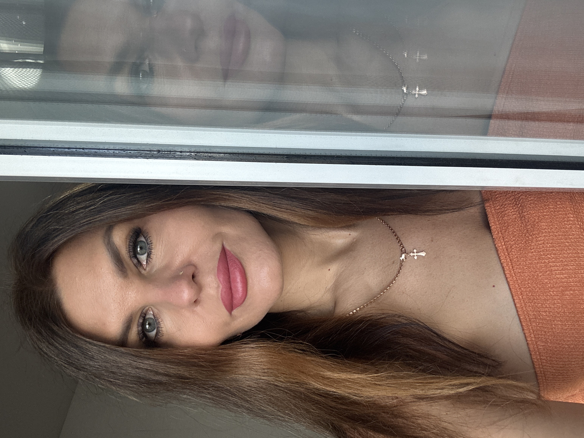 Woman photographs herself indoors in Chaikovsky, Russia