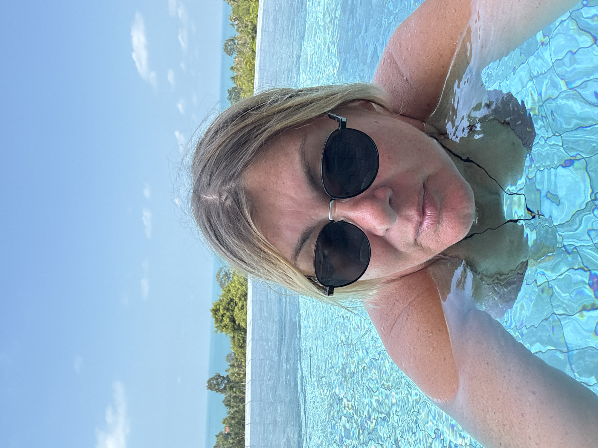 Tourist documents leisurely morning at Thai resort pool
