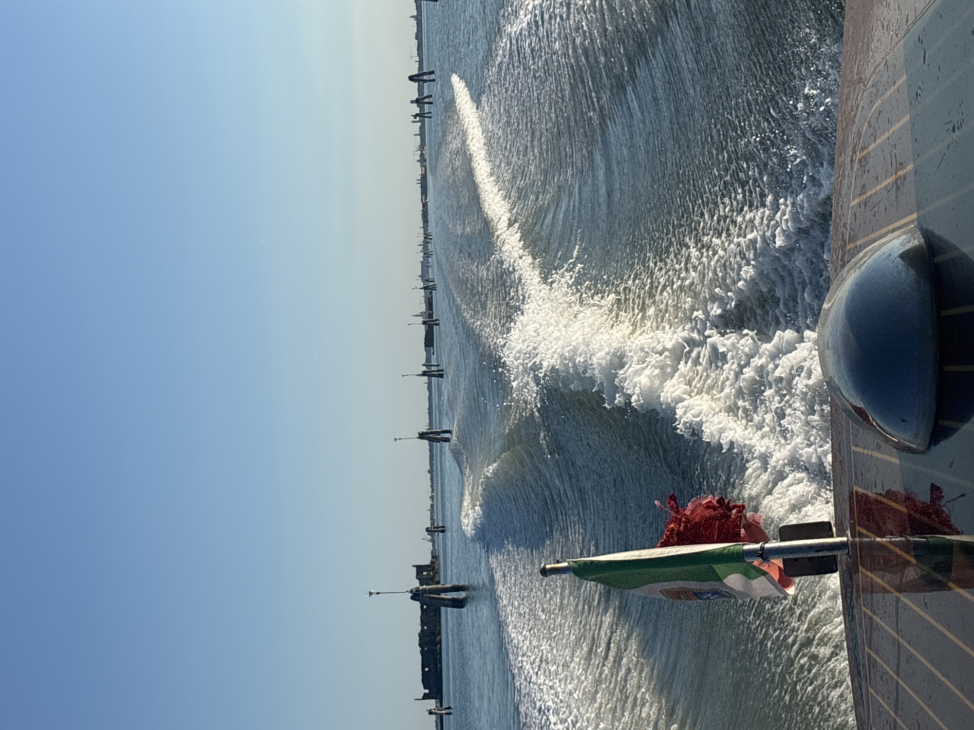 Boat wake on sun-lit Venice canals