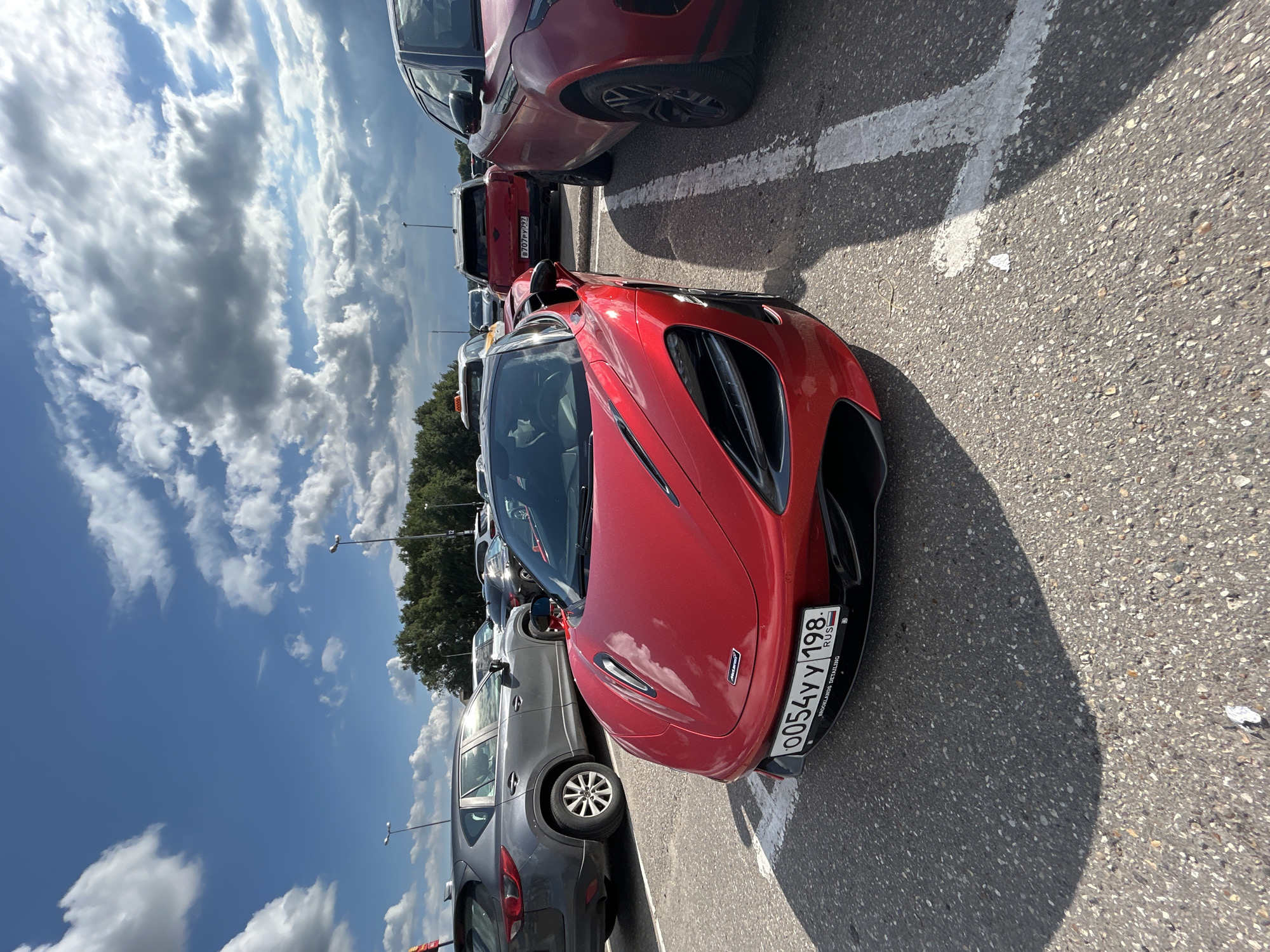 Red McLaren parked in a lot outside Pokrovskoe, Russia