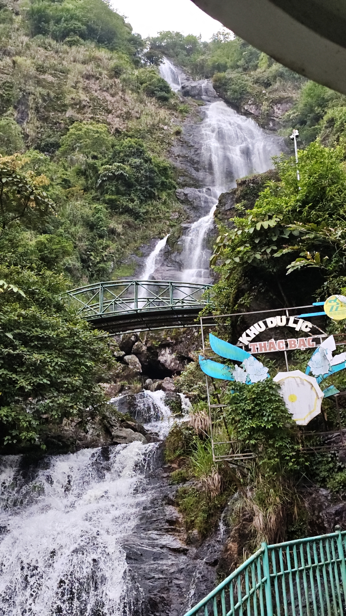 Tourist visits Sa Pa waterfall attraction in Vietnam