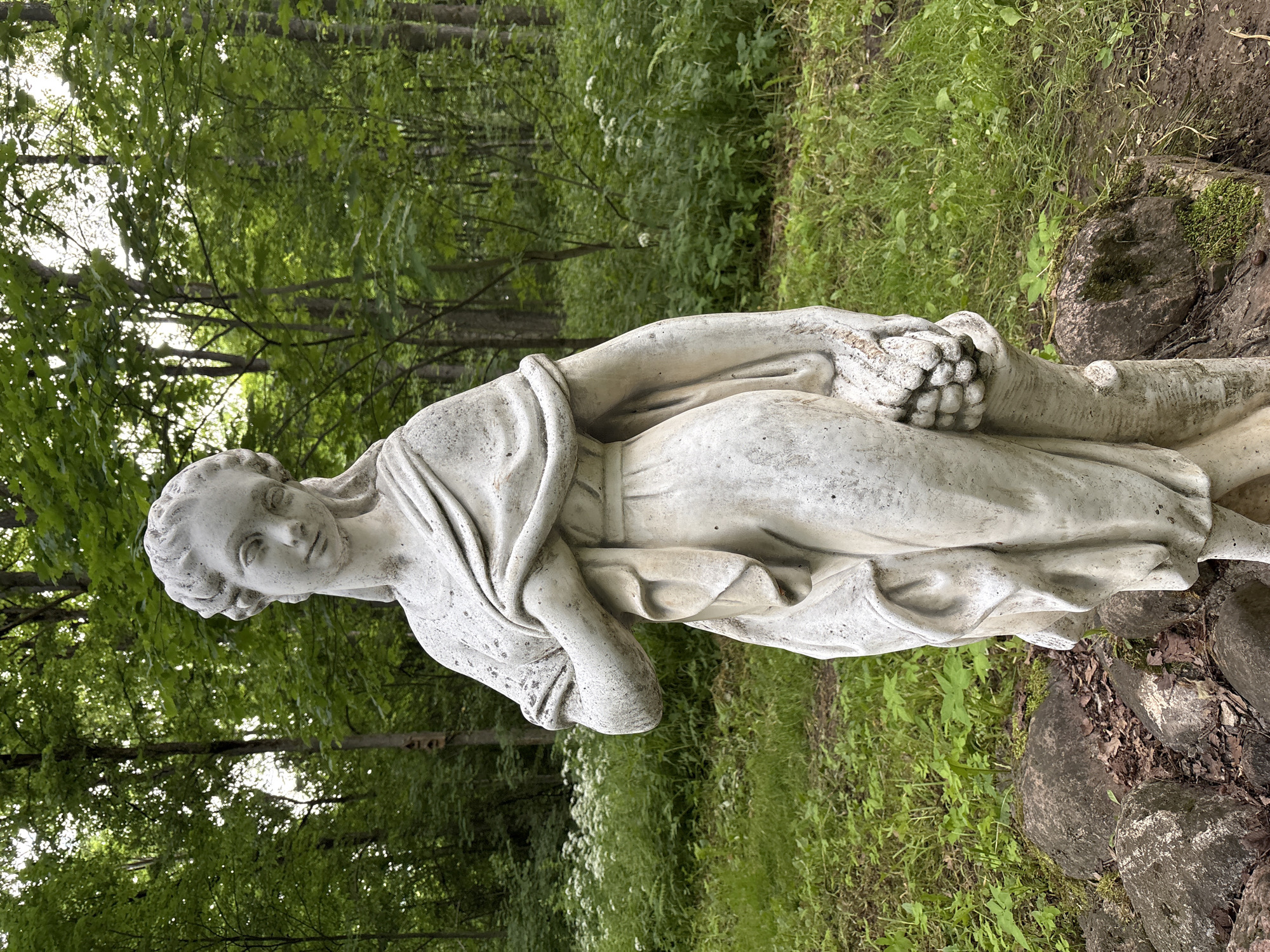 Weathered stone statue and spring at a Gorki park