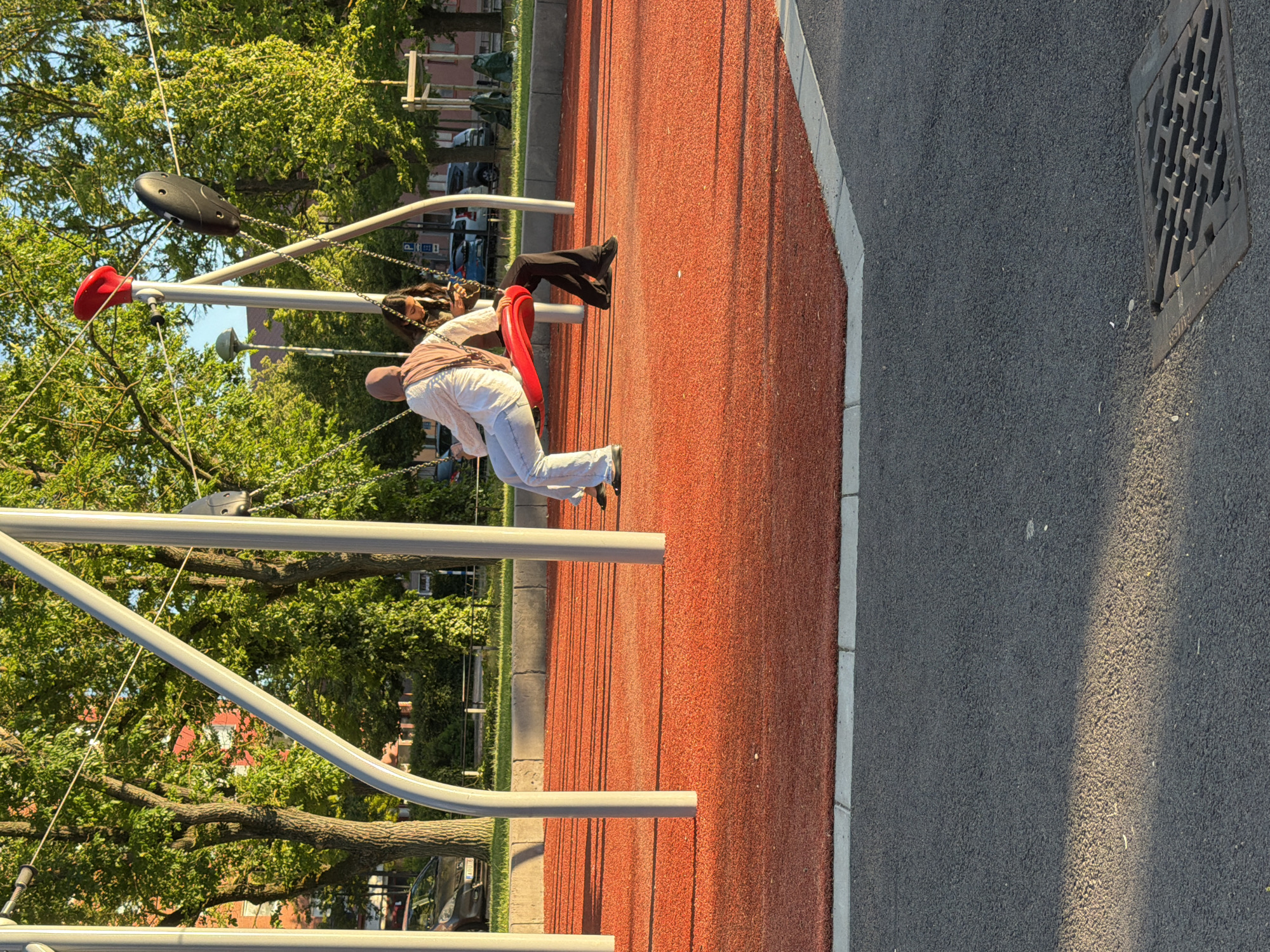Summer evening at a Helsingborg park playground and basketball court