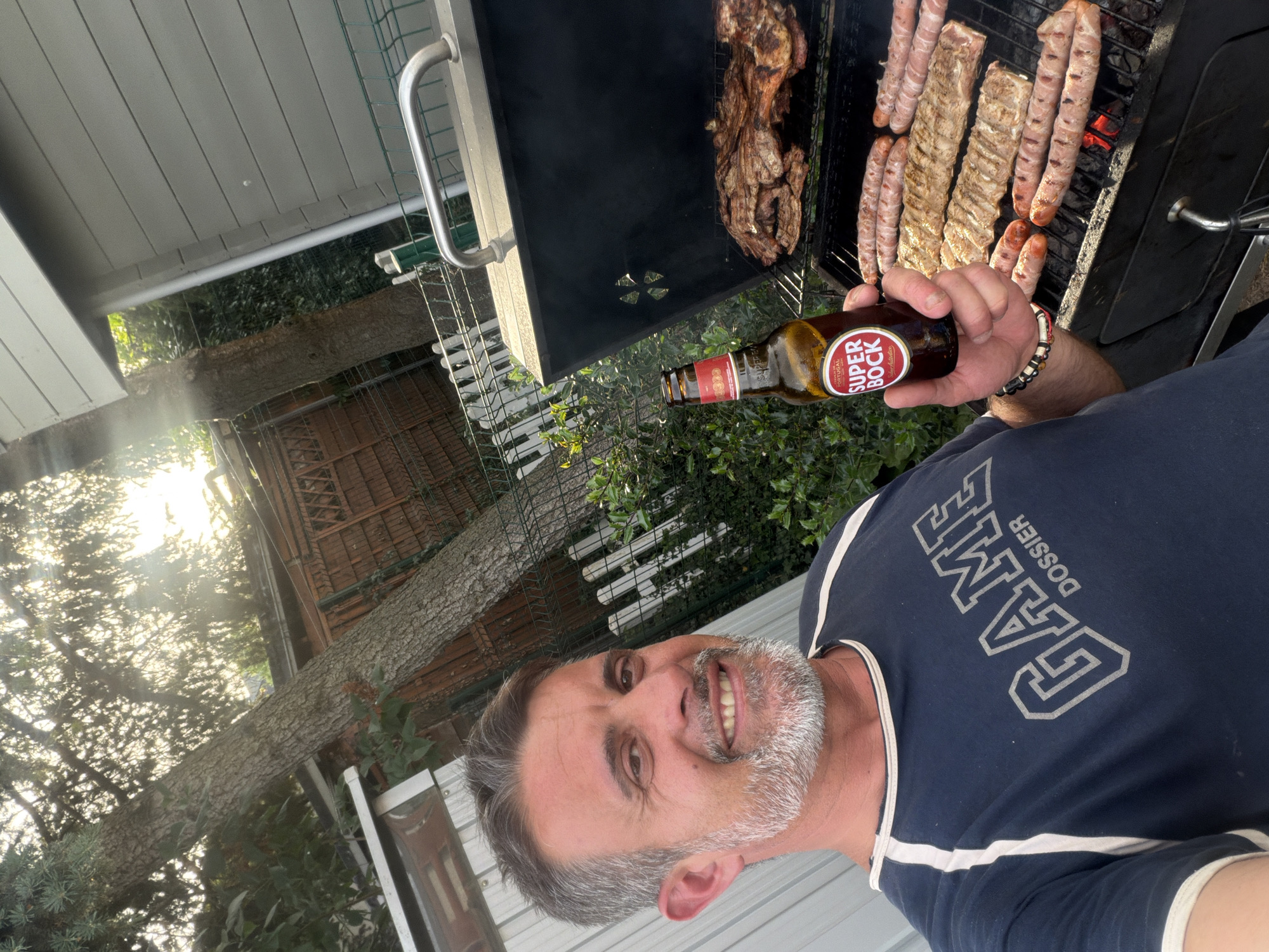 Man grills outdoors with beer in Esch-sur-Alzette Luxembourg