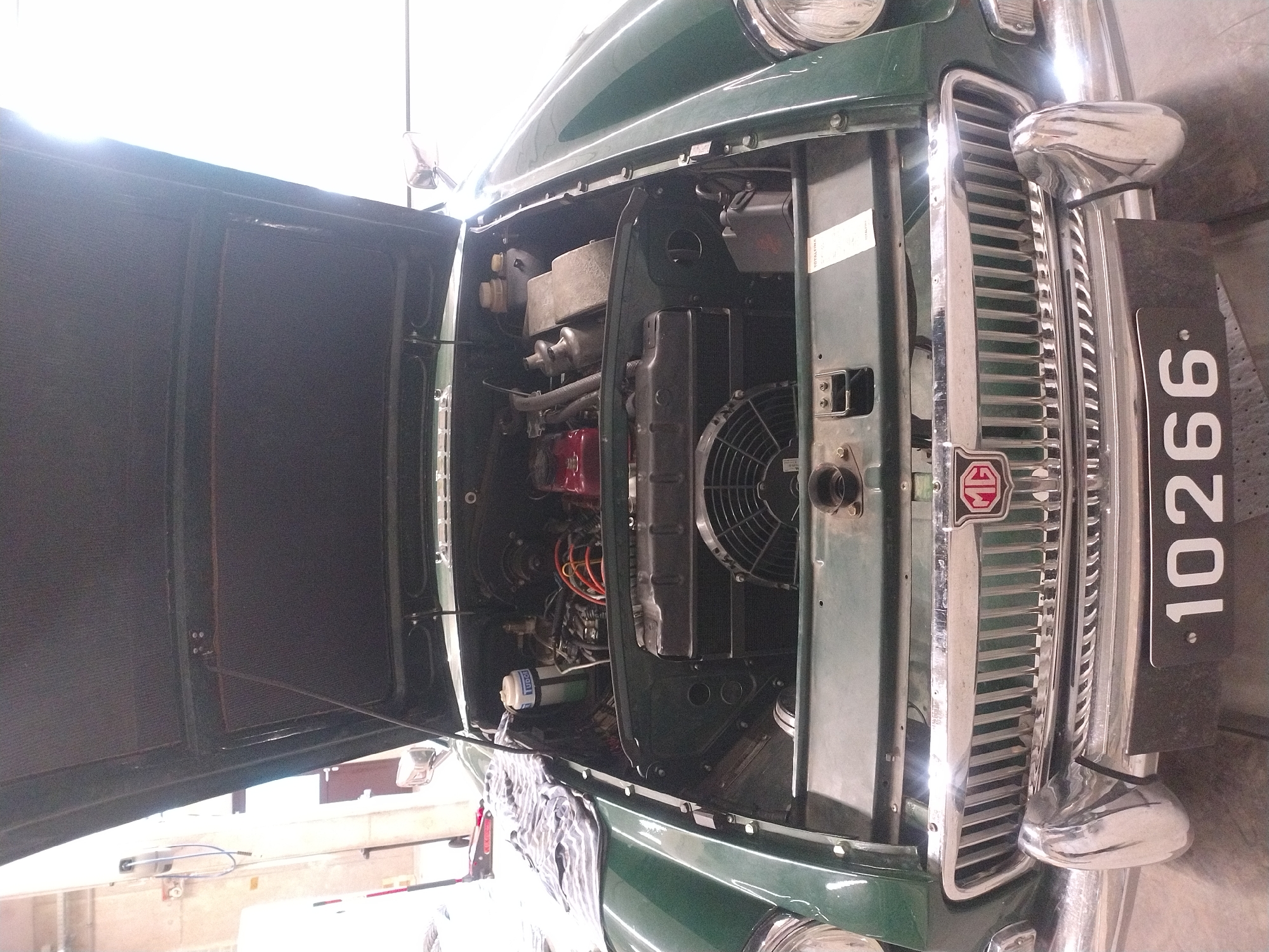 Classic MGB GT undergoes garage maintenance in Luxembourg