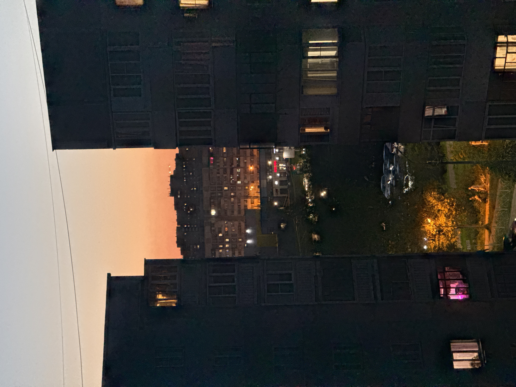 Crescent moon observed over Kazan apartment buildings at twilight
