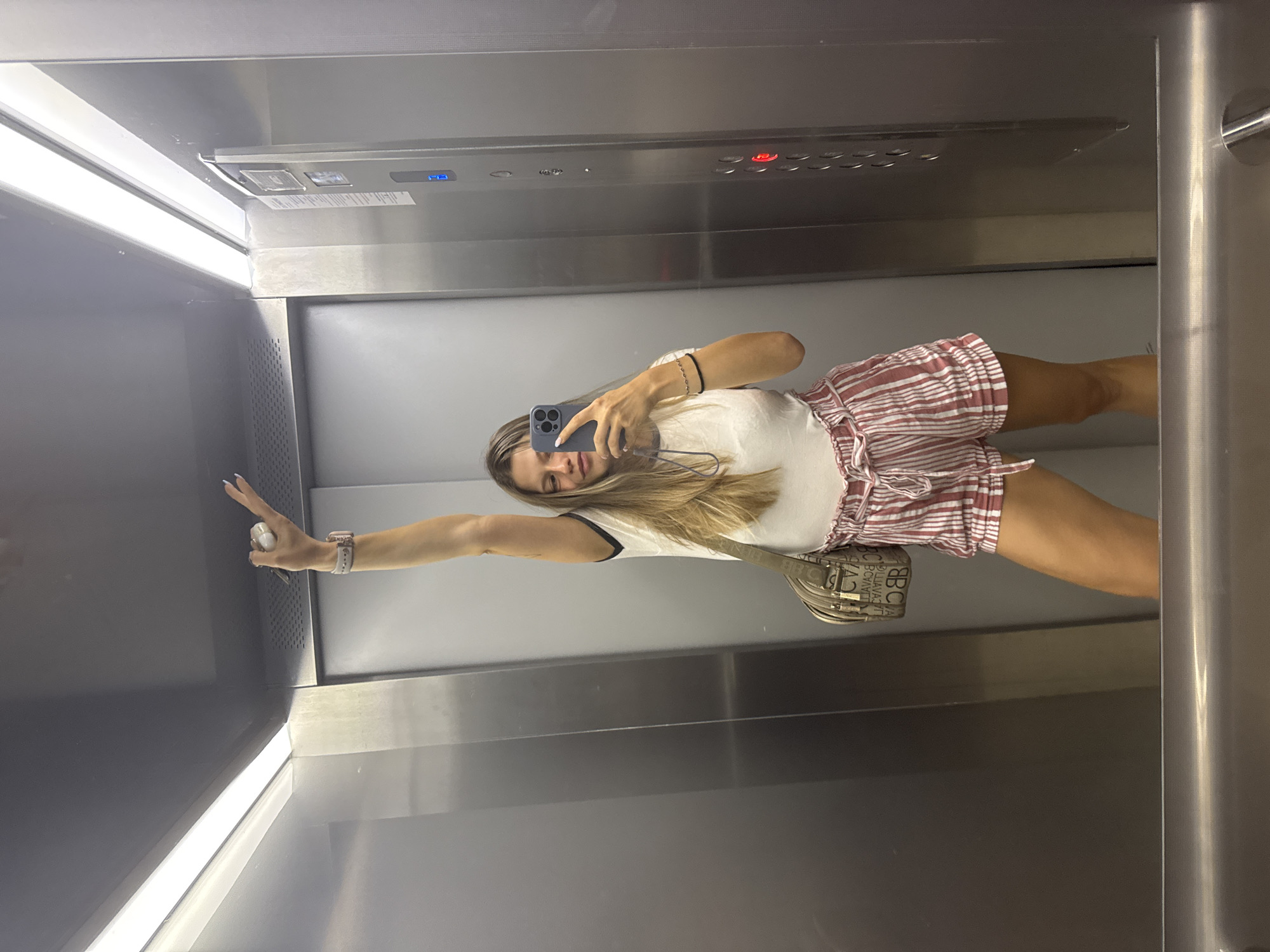Elevator mirror selfies in Sofia, casual outfit on display
