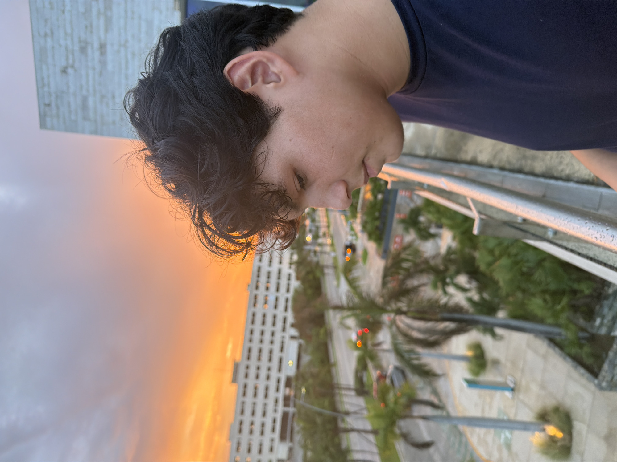 Cancún sunset from a balcony, sky lit up orange