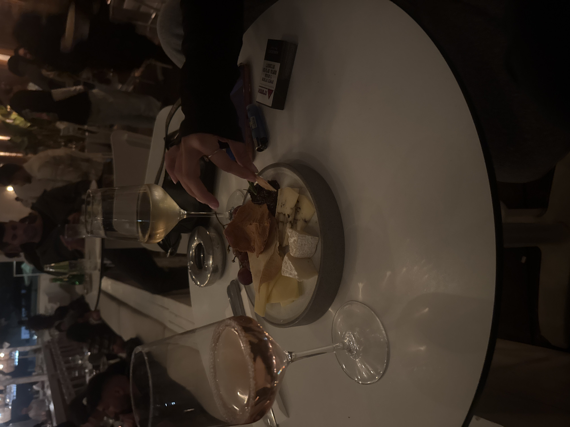 Evening dining scene captured at Herzliya restaurant with wine