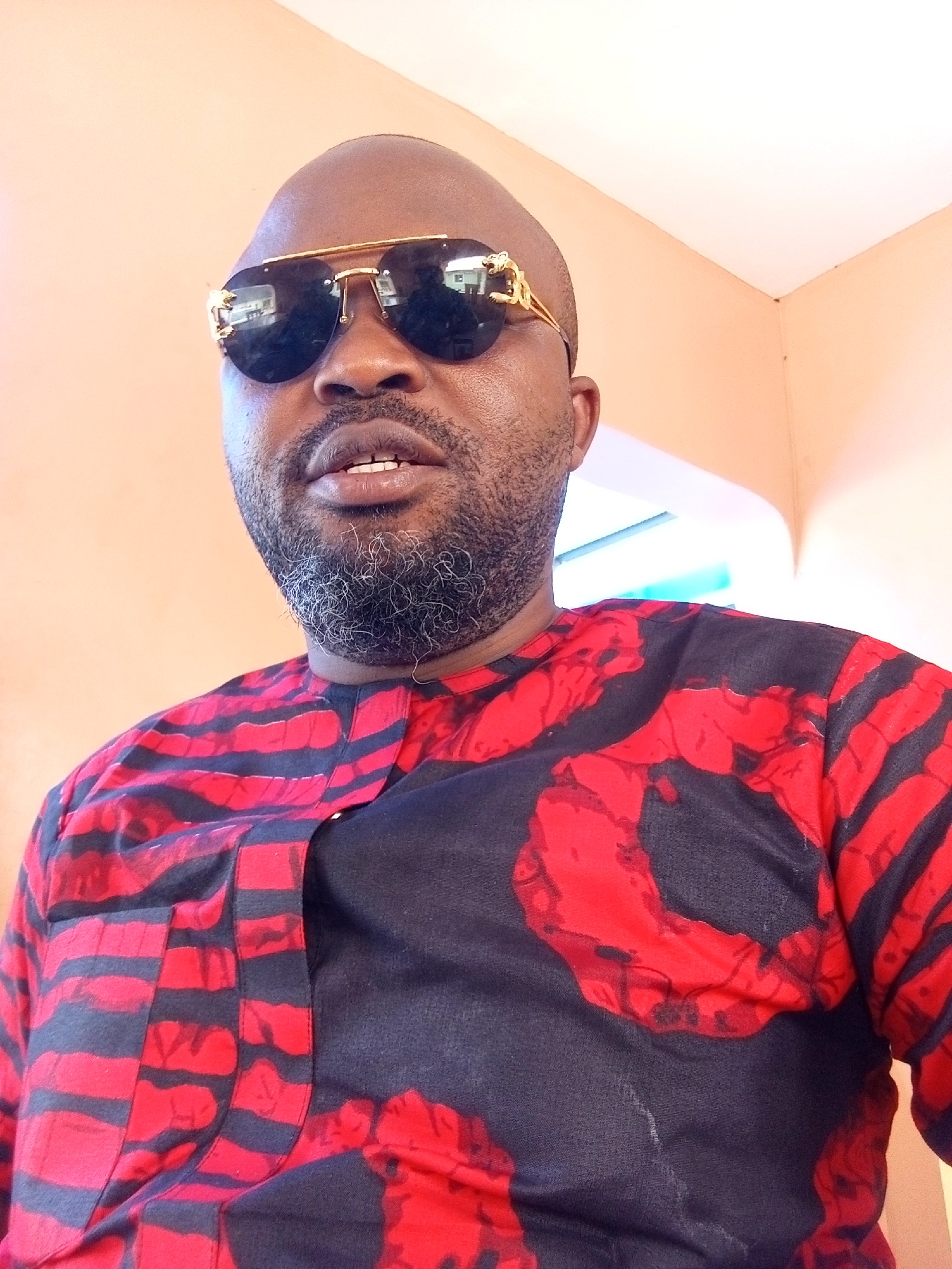 Man in patterned shirt photographed in Ankpa, Nigeria