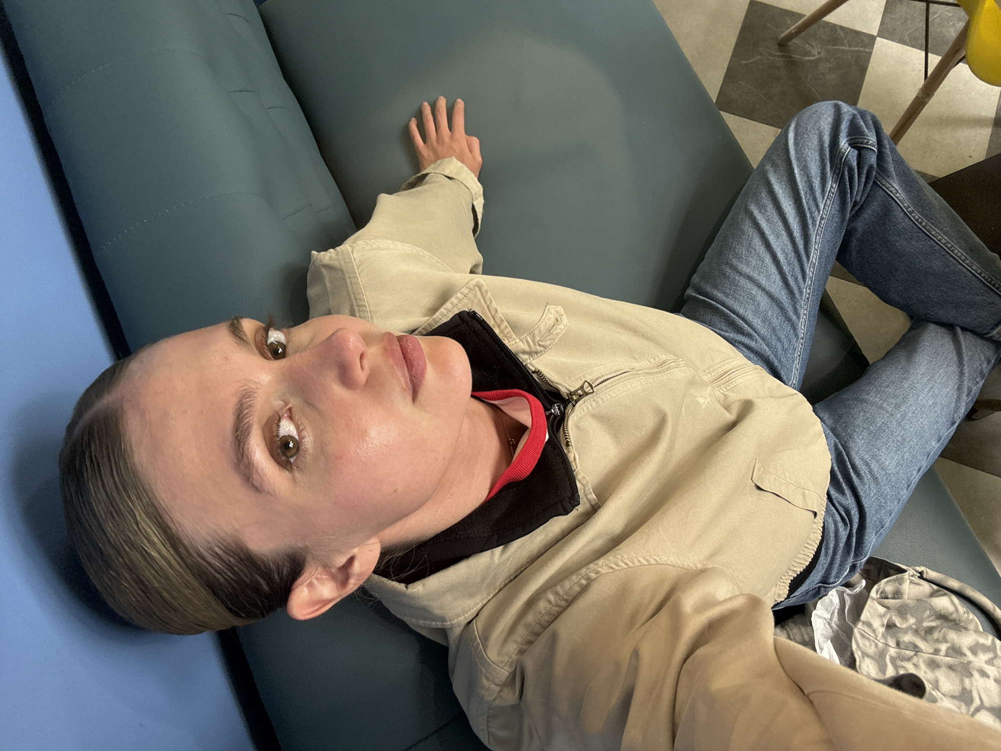 Woman resting on couch in Tbilisi indoor setting