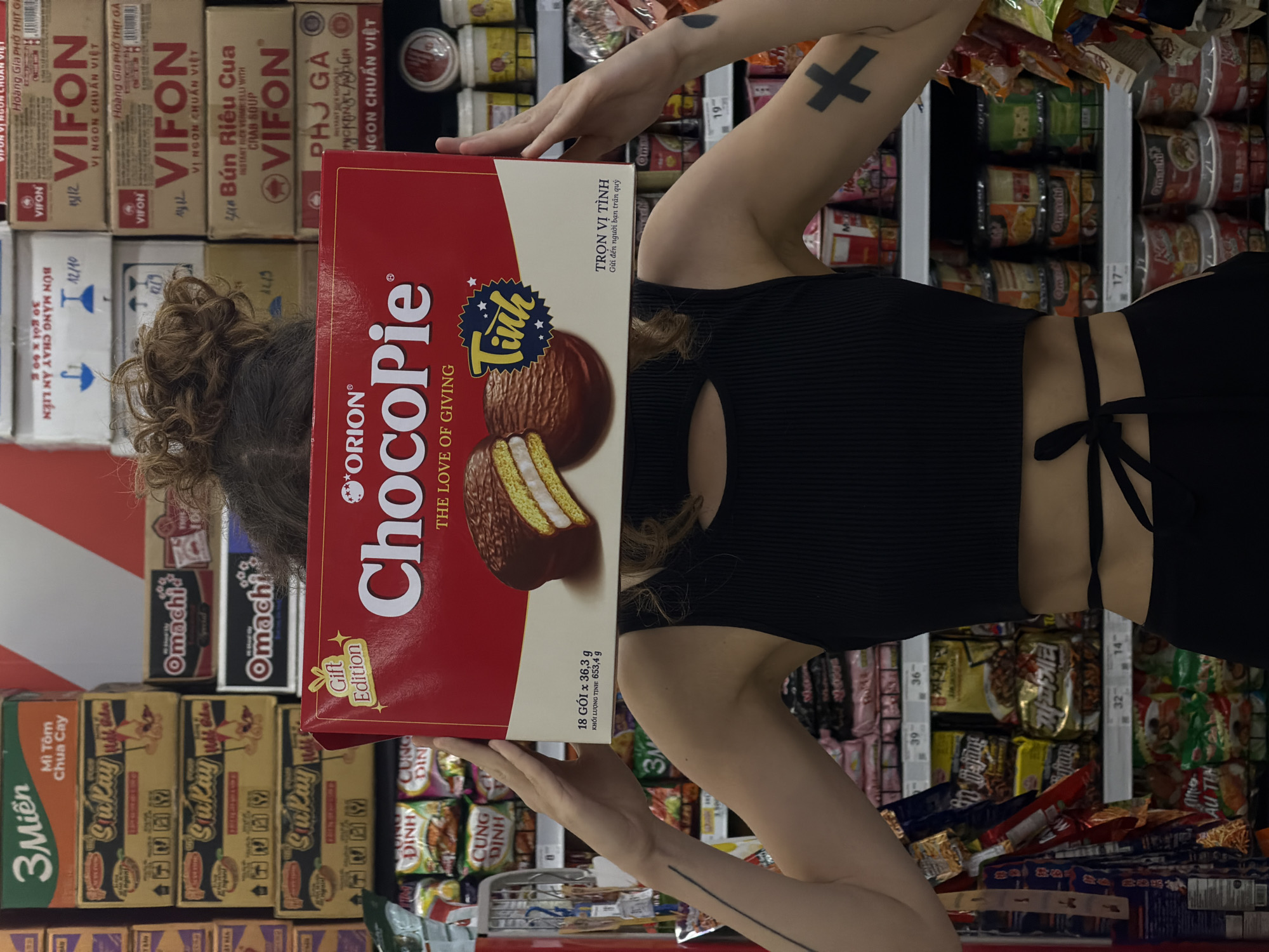 Shopper poses with ChocoPie box covering face in Đà Nẵng supermarket