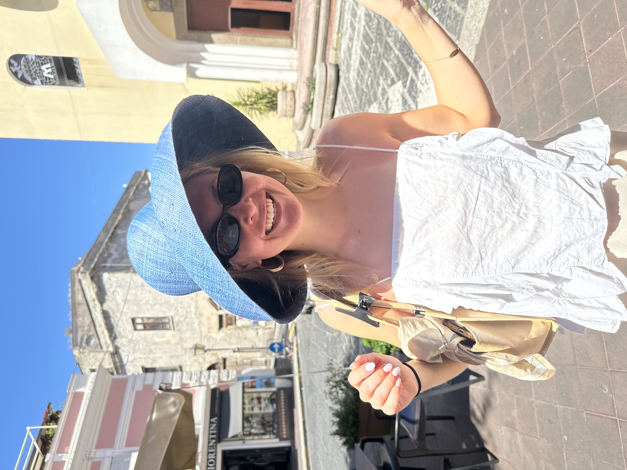 Woman photographed on sunny street in Lipari, Italy