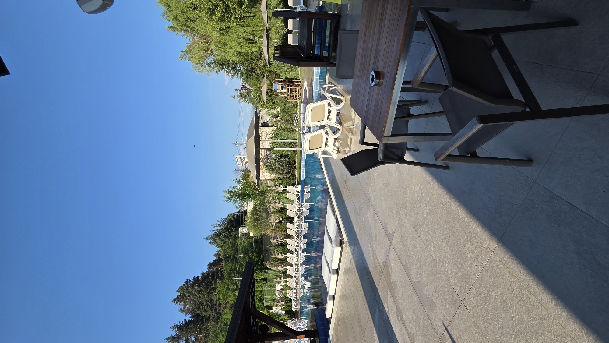 Pool area and restaurant at a leisure property, day to dusk