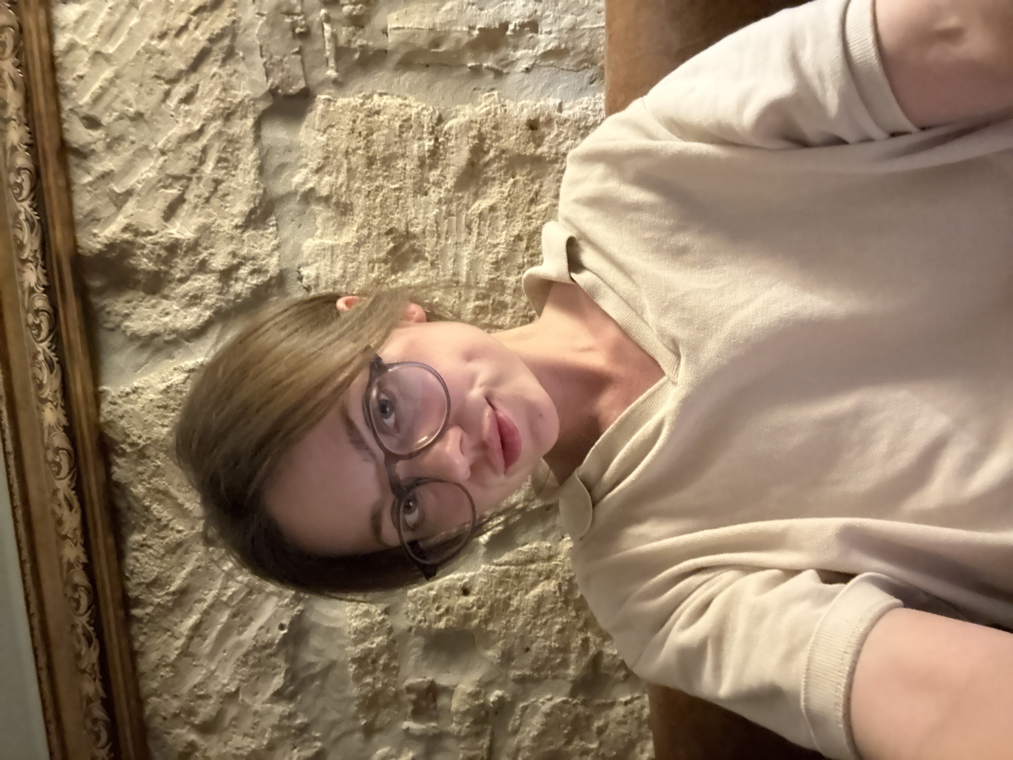 Woman takes casual selfies indoors in Budapest