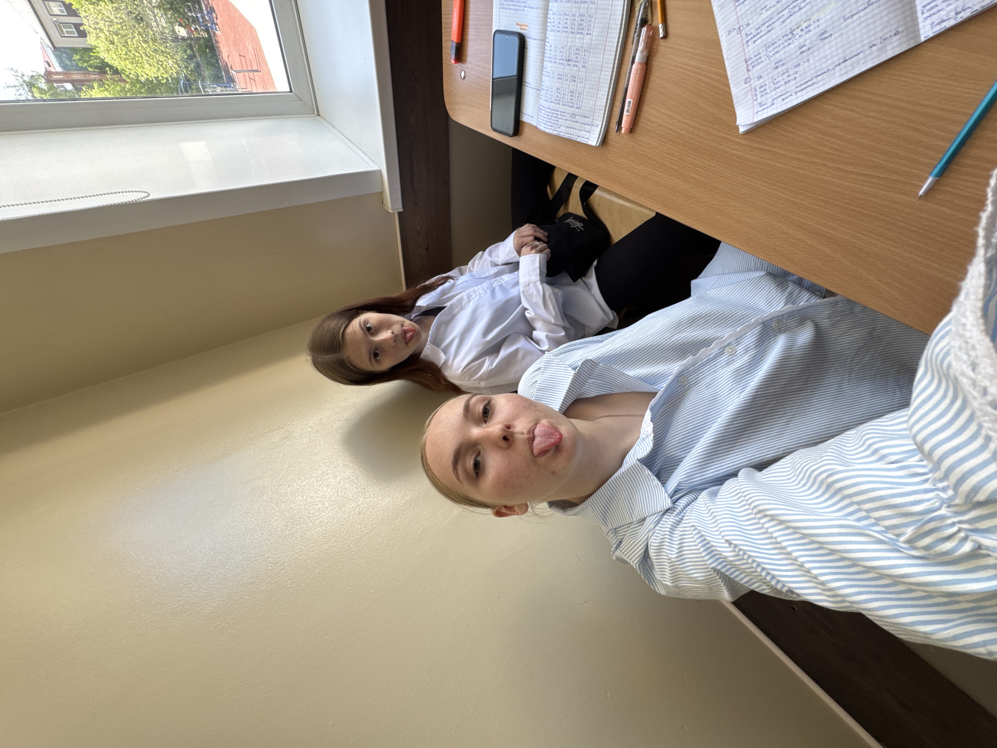Young women photograph themselves indoors in Perm, Russia