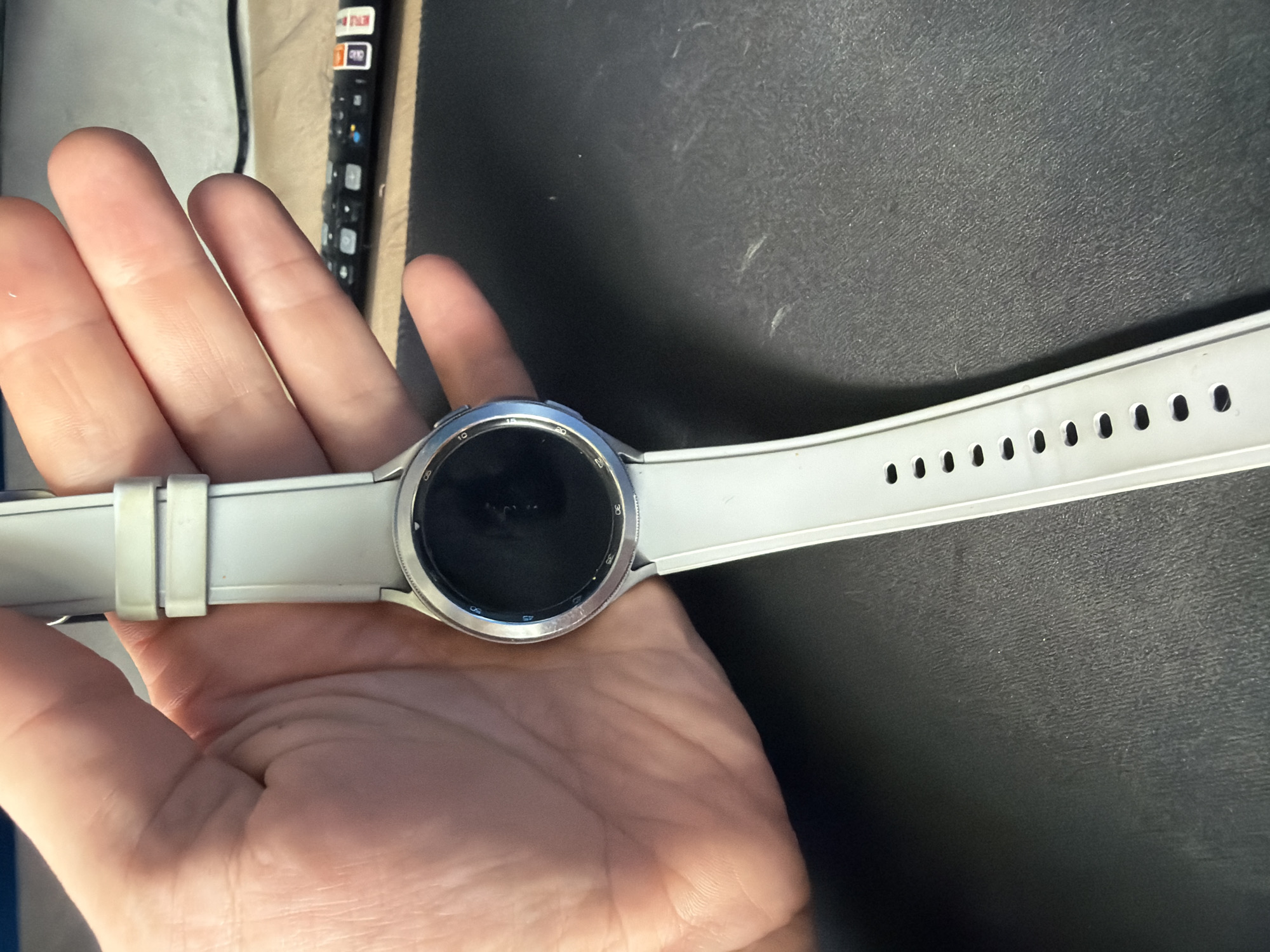 Person holds smartwatch in Chaikovsky, Russia morning scene