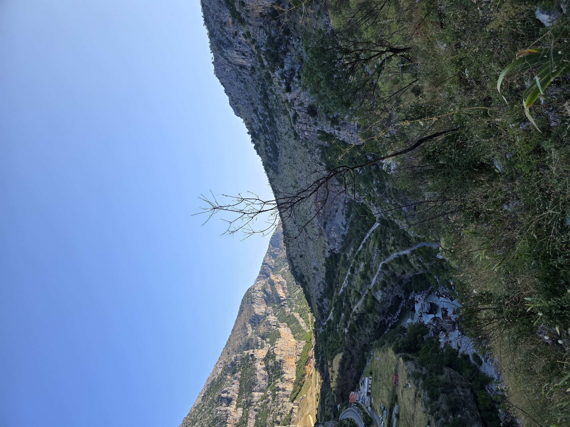 Dog hike along towering cliffs above a riverside valley
