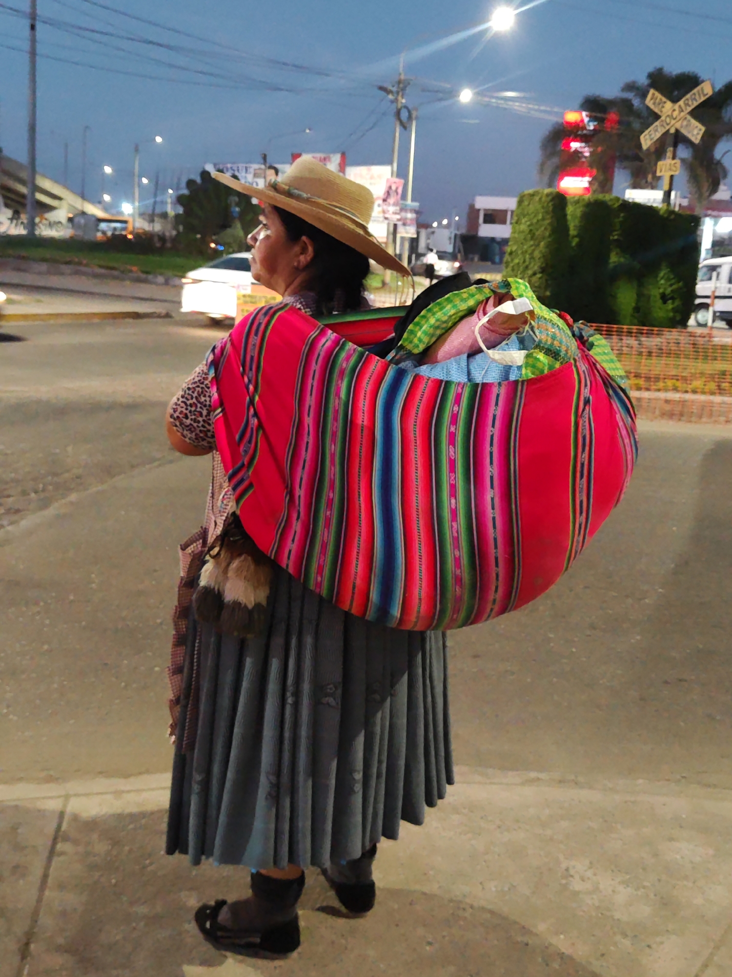Evening religious devotion and street life documented in Tacna