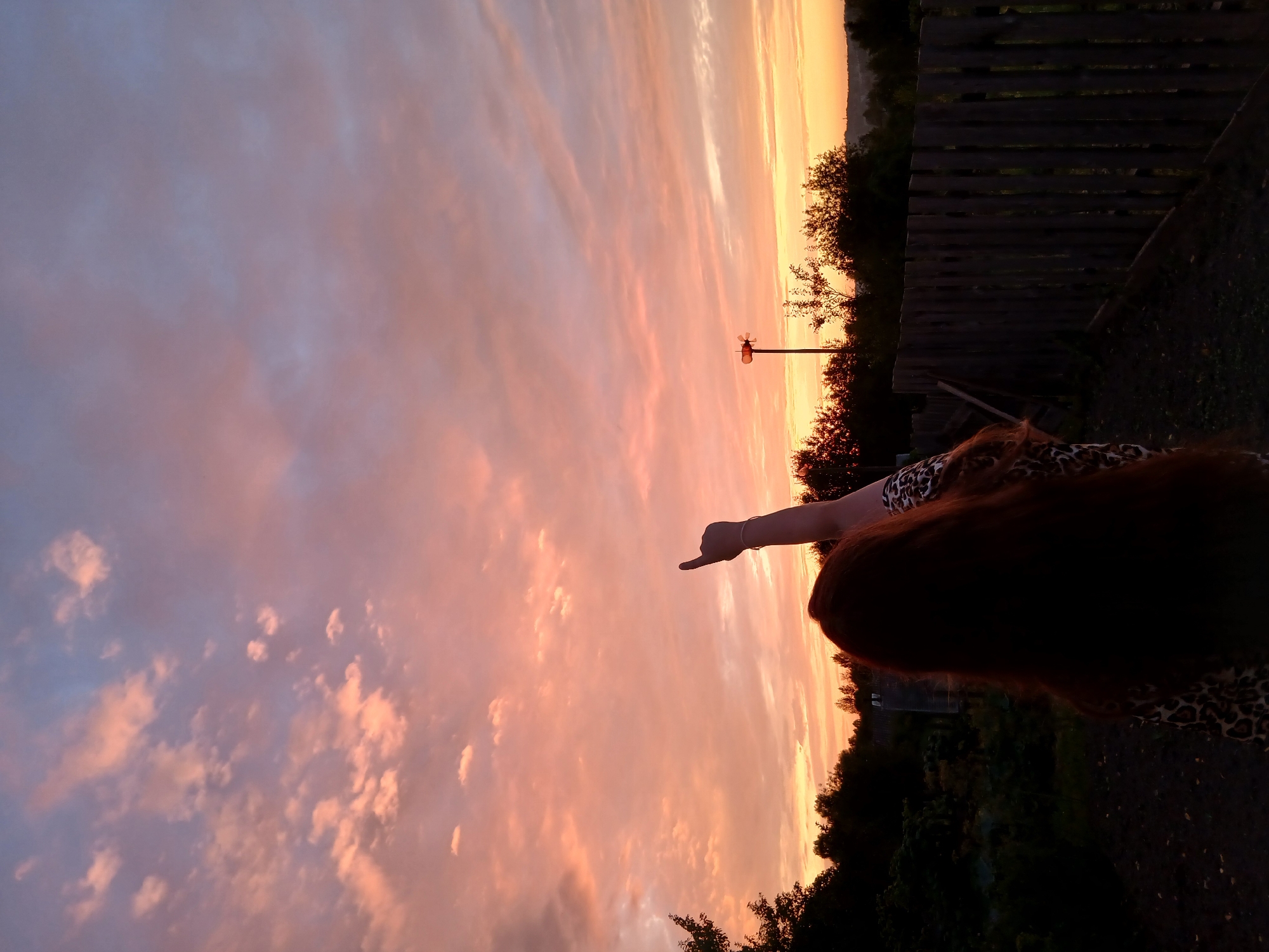 Rainbow and pastel dusk sky over a rural property