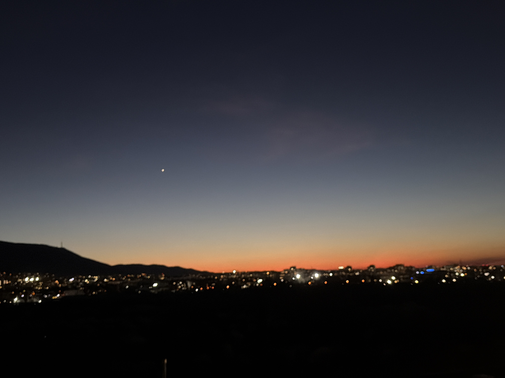 Twilight cityscape captured in Sofia with bright sky object