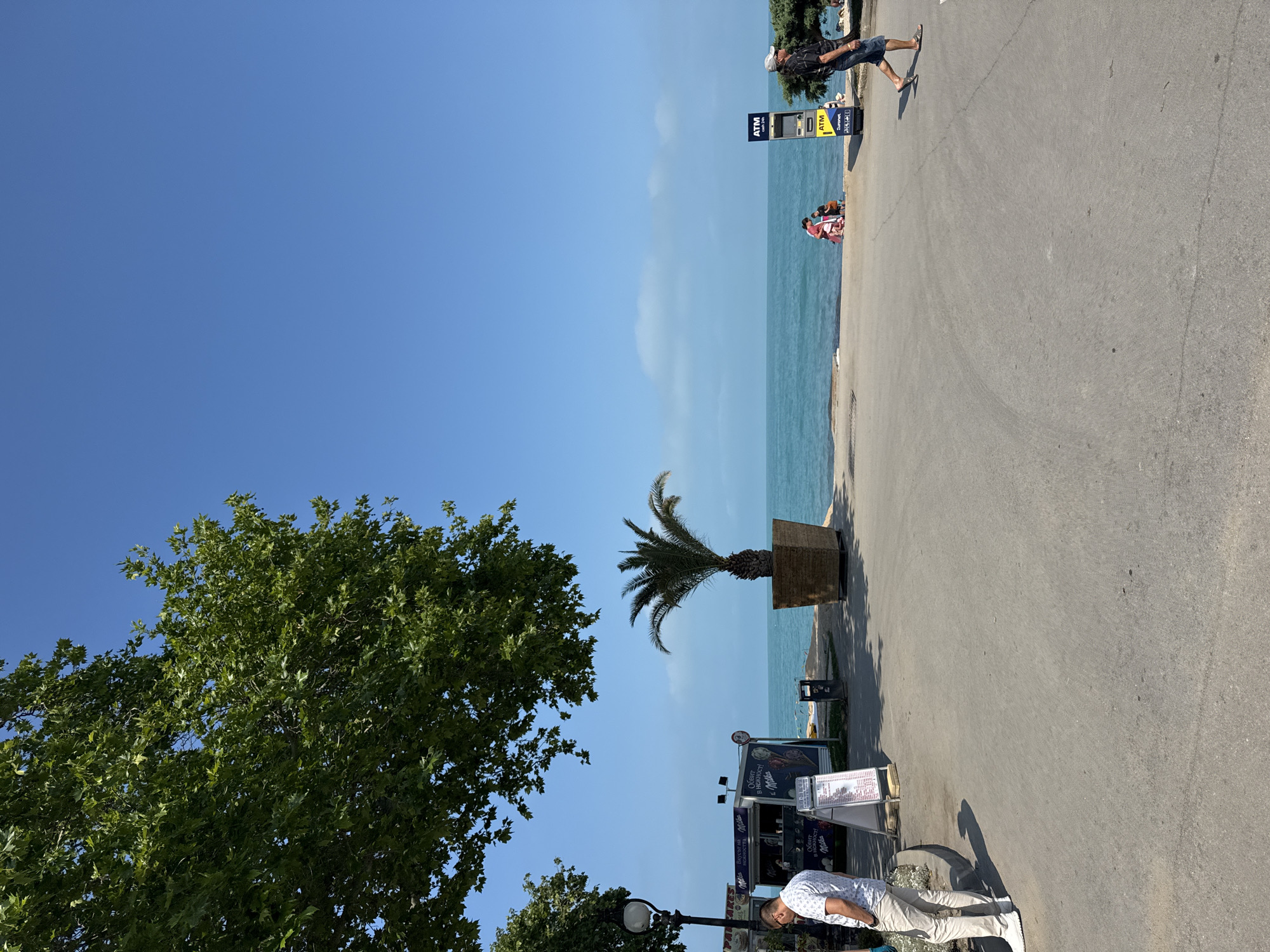 Sunny waterfront promenade with resort facilities documented by witnesses