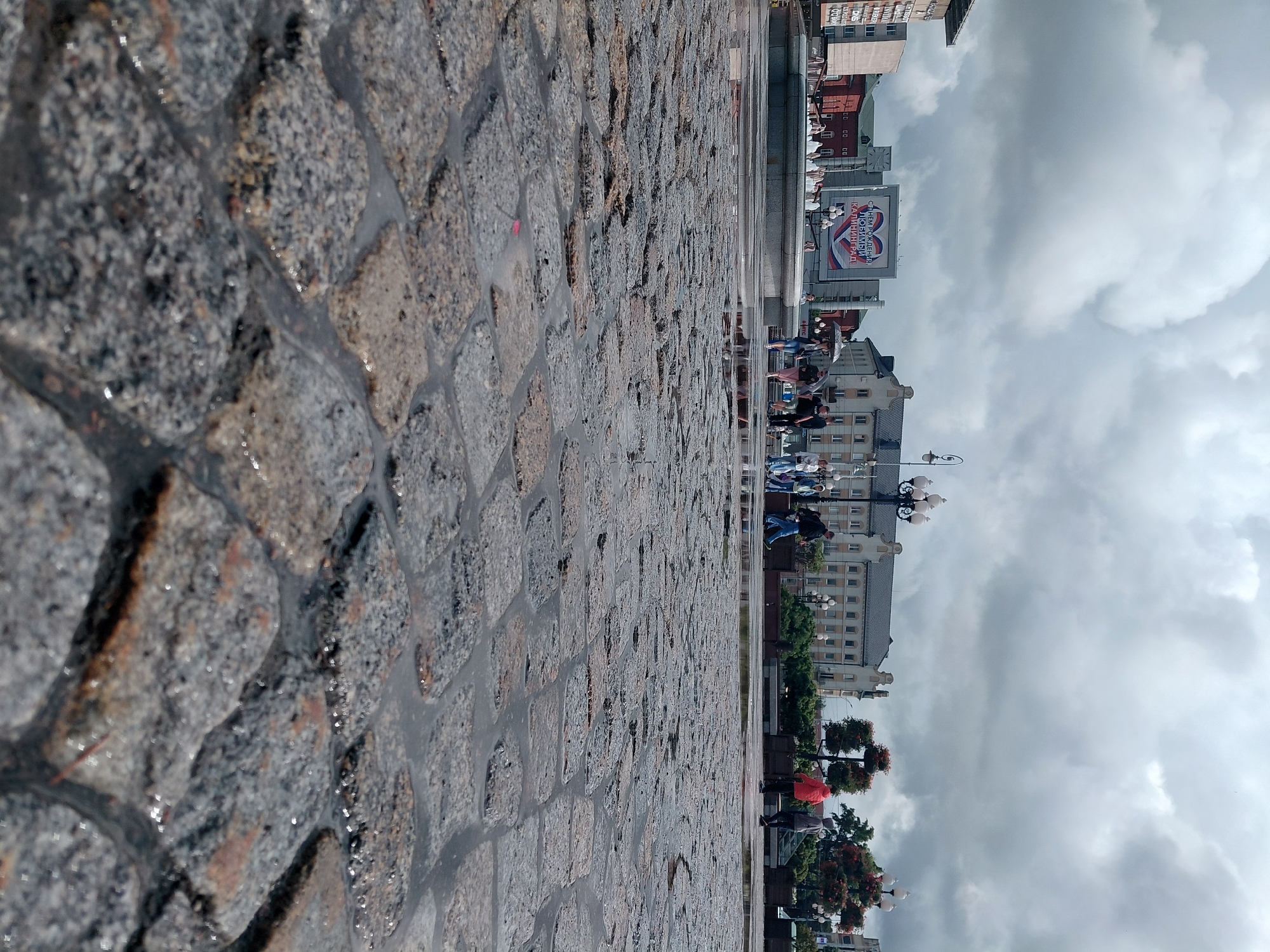 Rainy city afternoon: streets, fountains, and neon-lit interiors