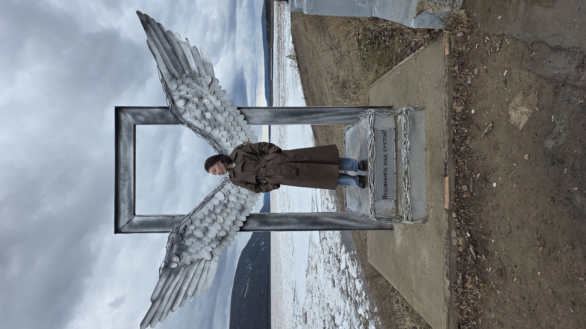 Woman poses in angel wings sculpture in Lensk, Russia