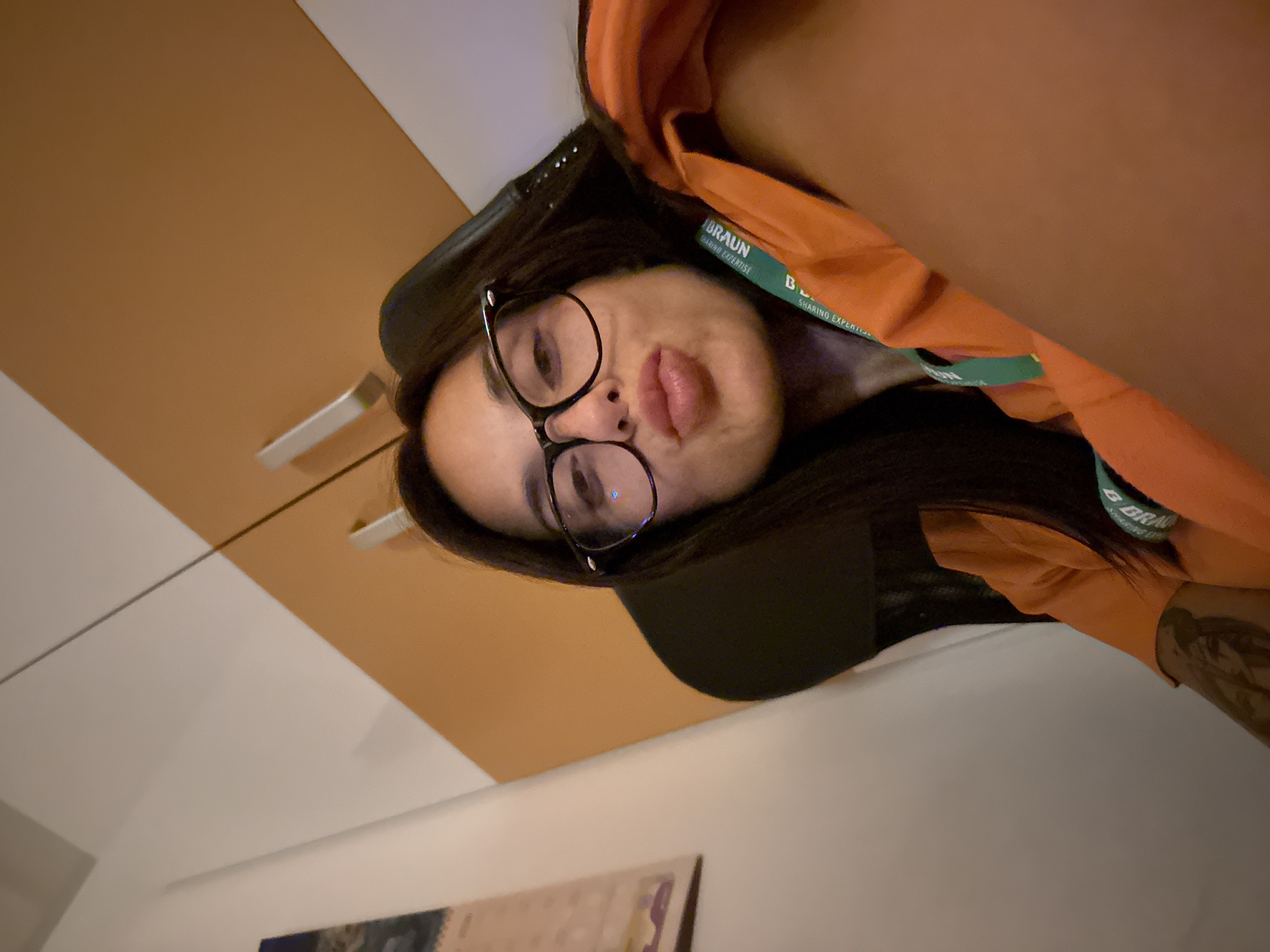 Indoor selfie with orange shirt and green lanyard, Pleven