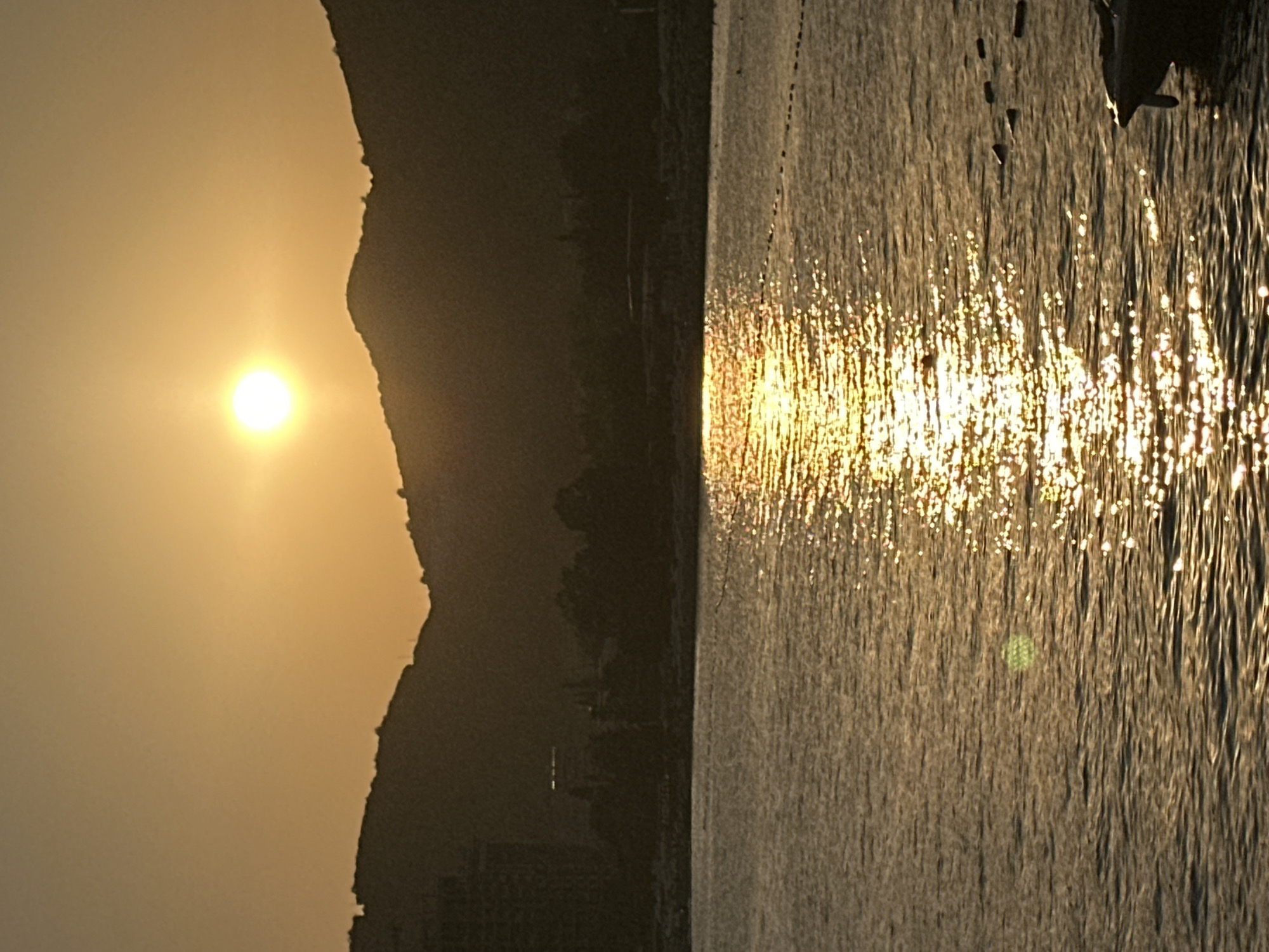 Sunset over Budva's calm Adriatic waters with boats nearby
