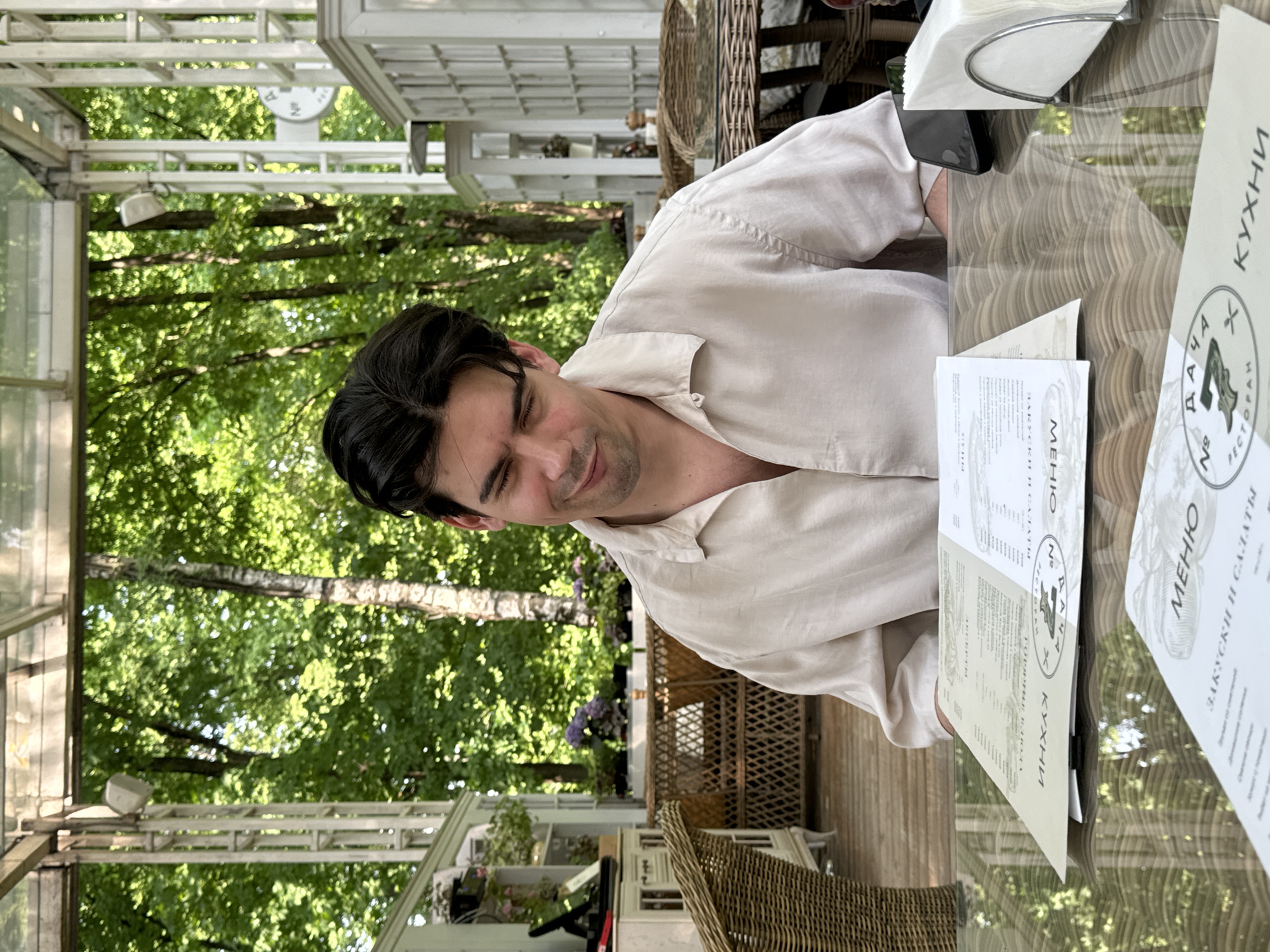 Man feeds ducks during outdoor breakfast in Arkhangel'skoye