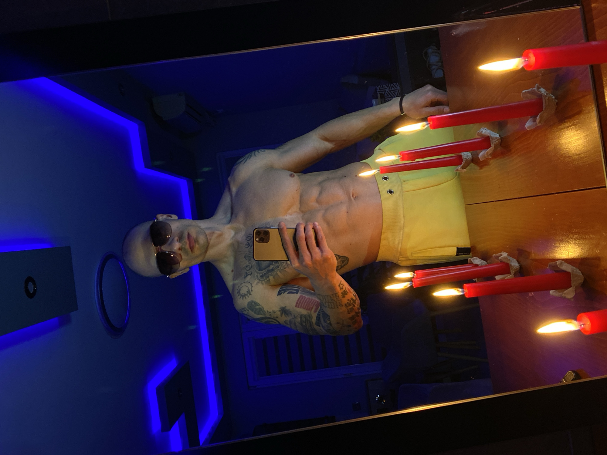 Man takes mirror selfie in neon-lit room in Pleven