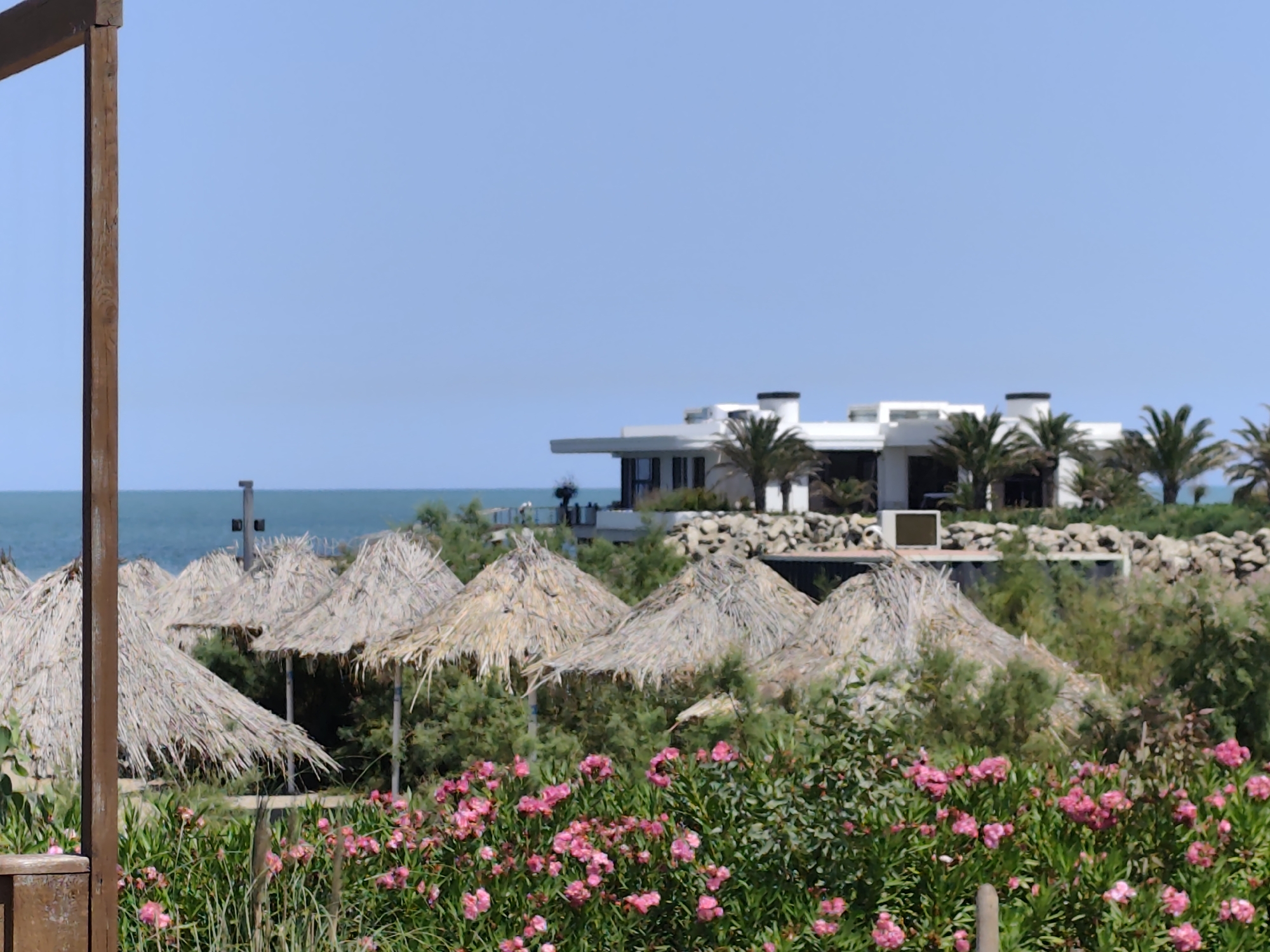 Sunny morning at a beach resort with a wooden ship structure