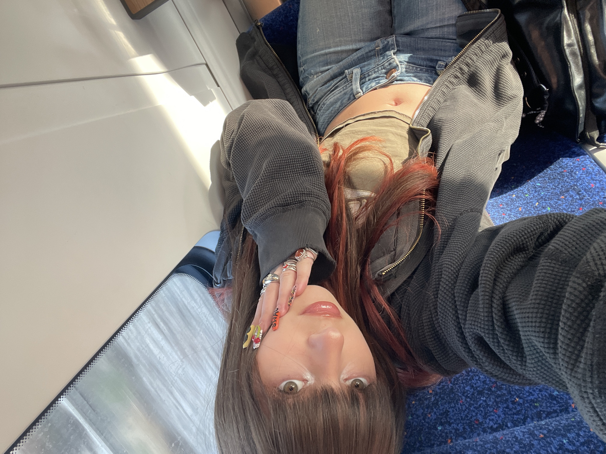 Person rests on train seat in Ramat HaSharon