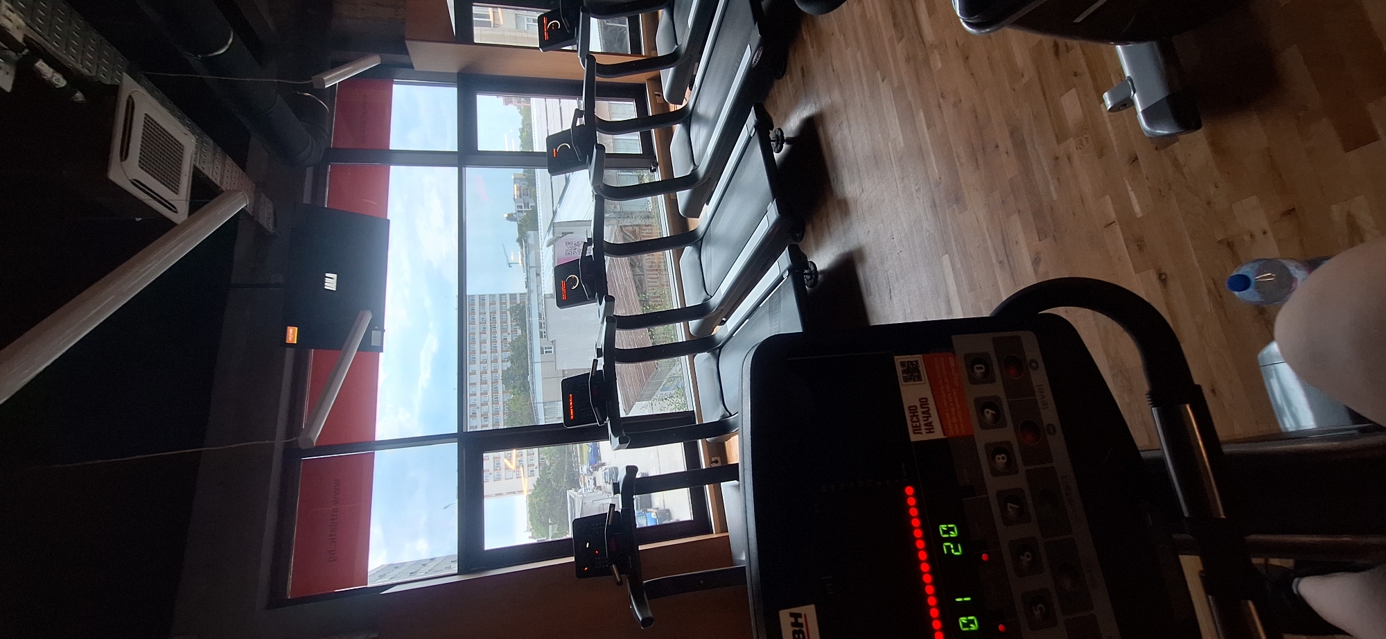 Midday gym session with city views and floor training