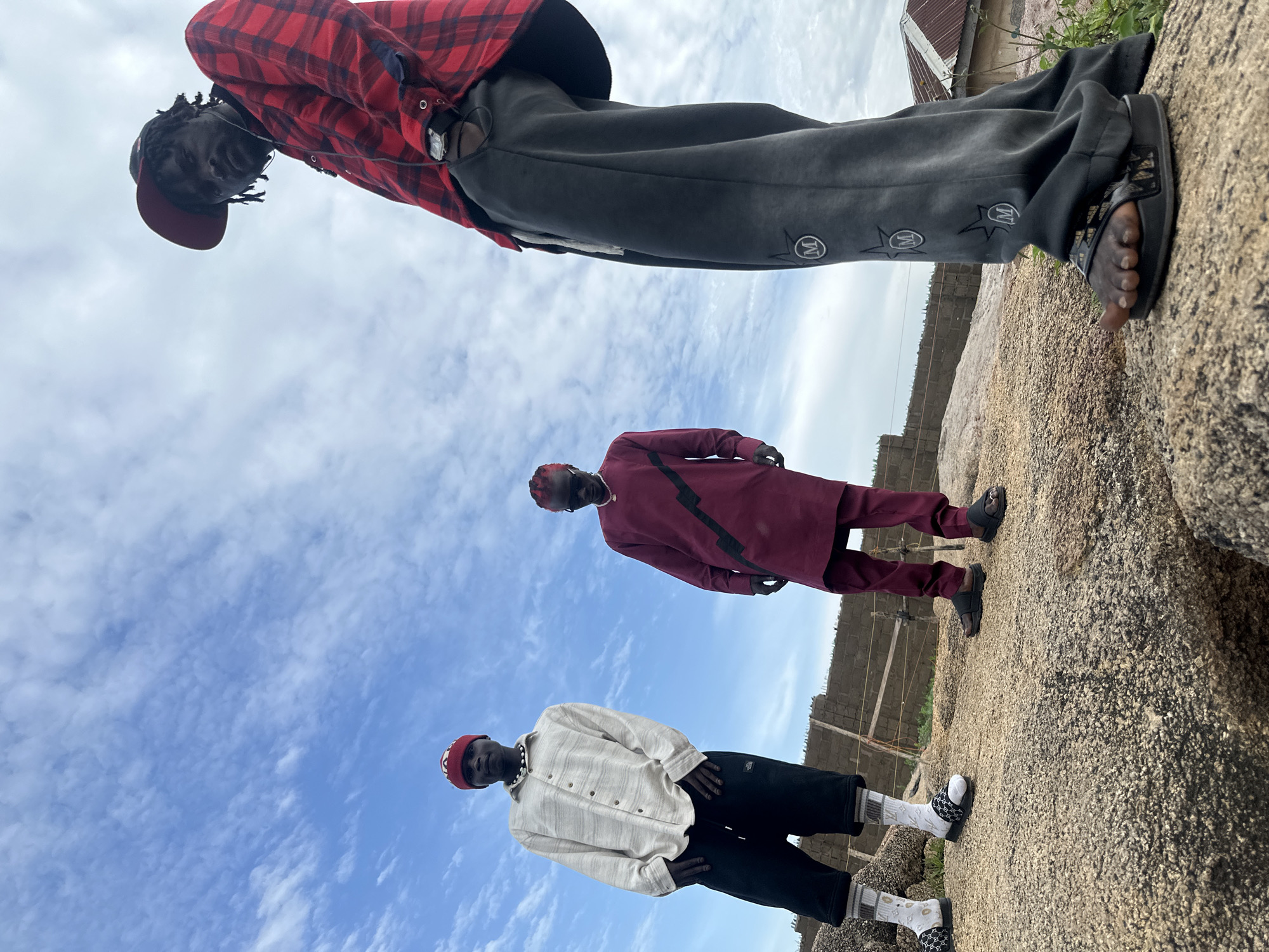 Crew posing on Jos granite rocks on a cloudy afternoon