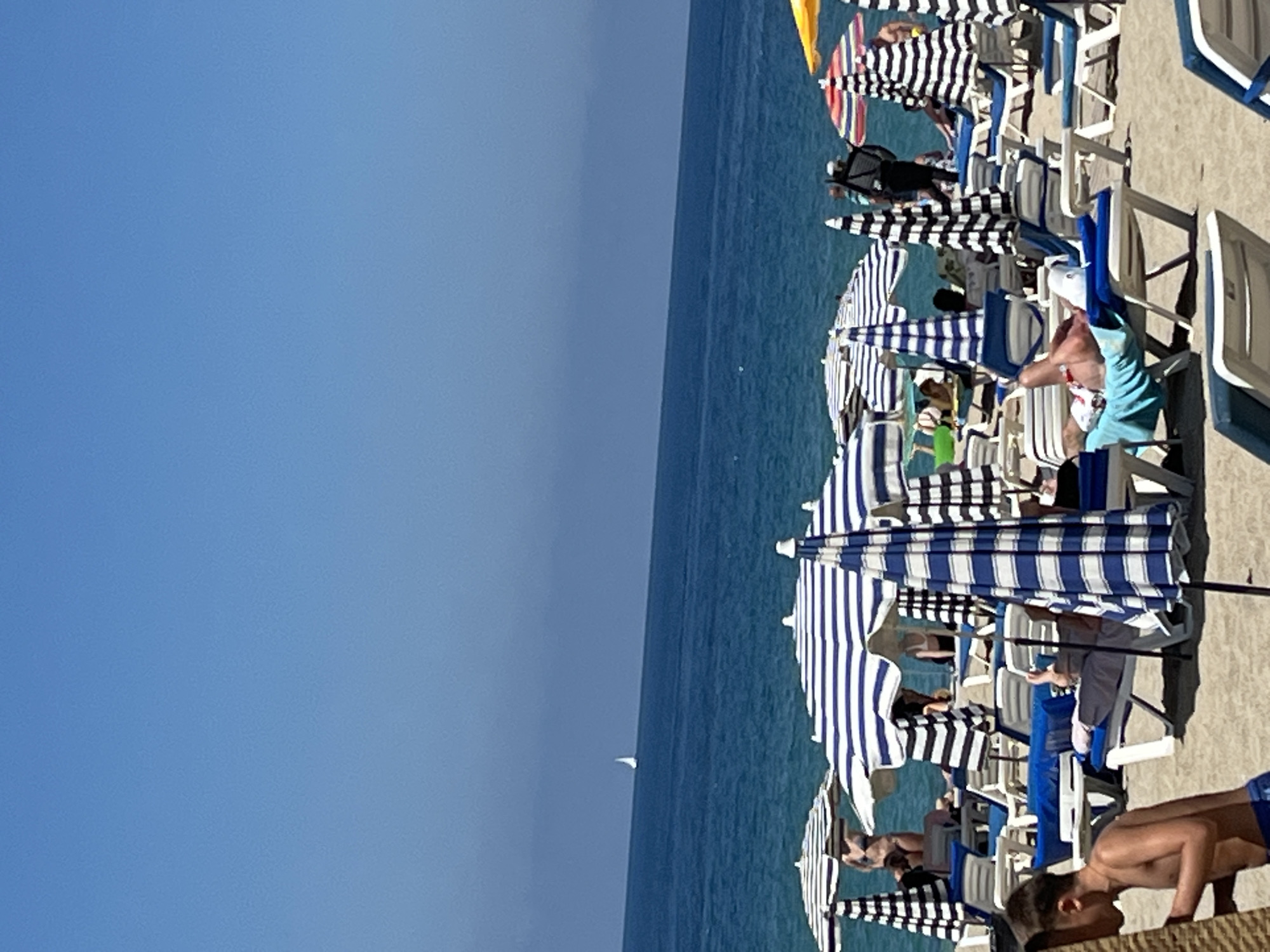 Morning beach crowds gather under umbrellas in Alanya, Turkey