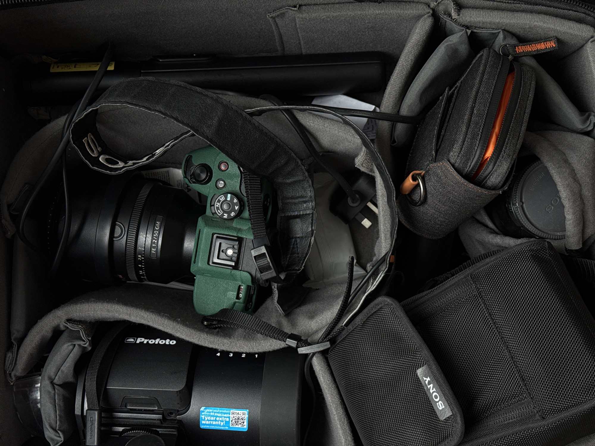 Photographer organizes equipment in camera bag in Dubai