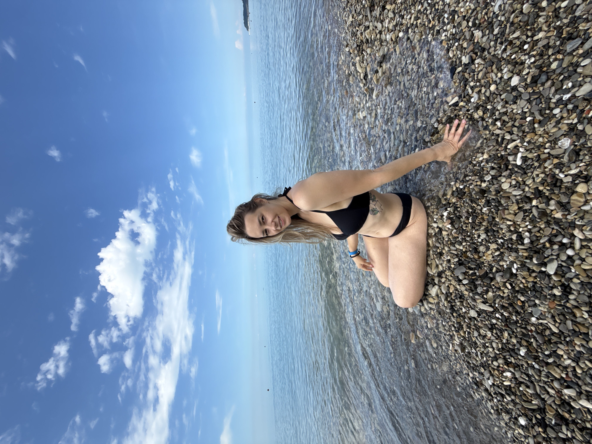 Woman enjoys early morning beach time in Nebug, Russia