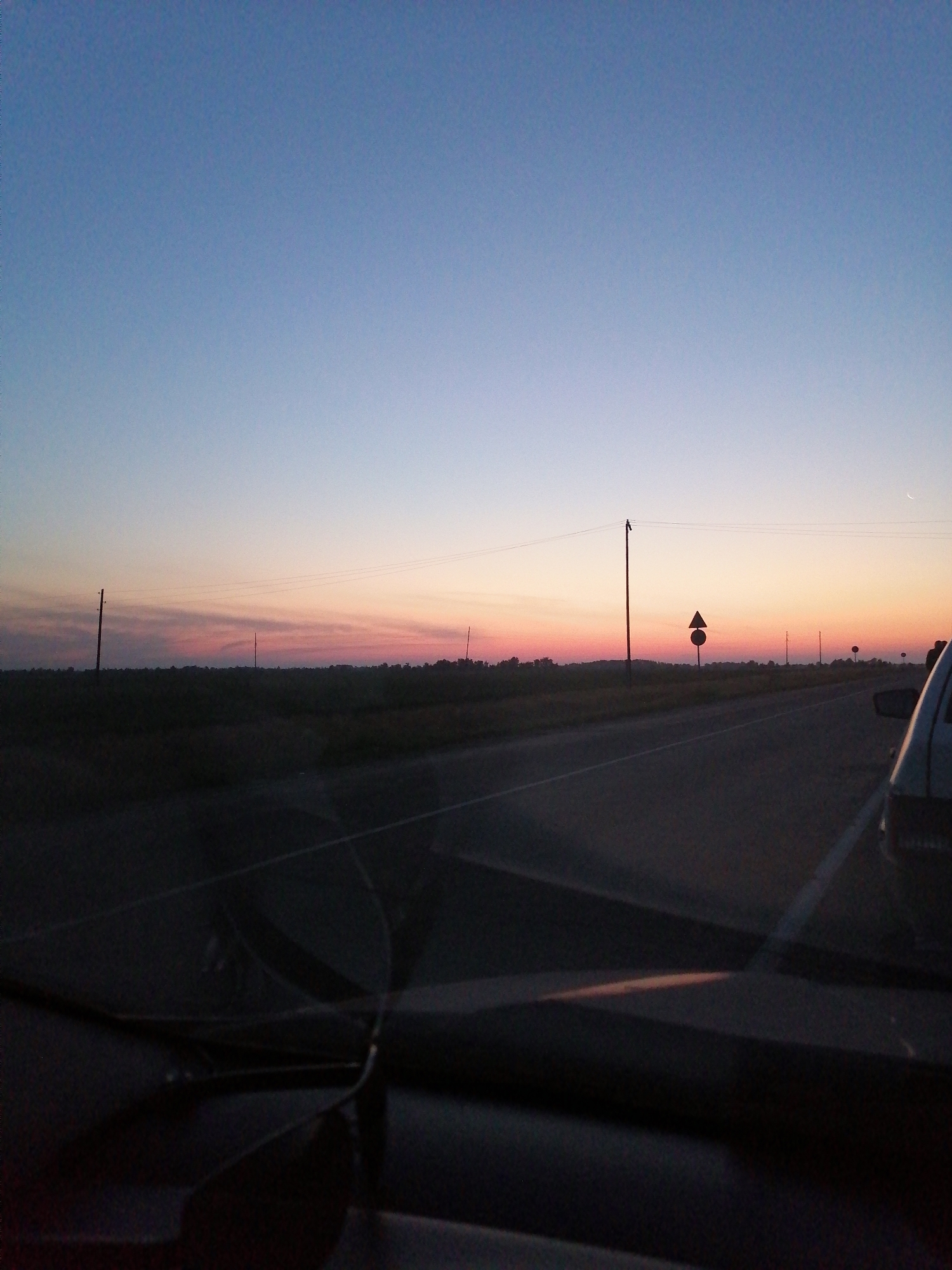 Driving into a pastel sunset, Russian tribute decal in view