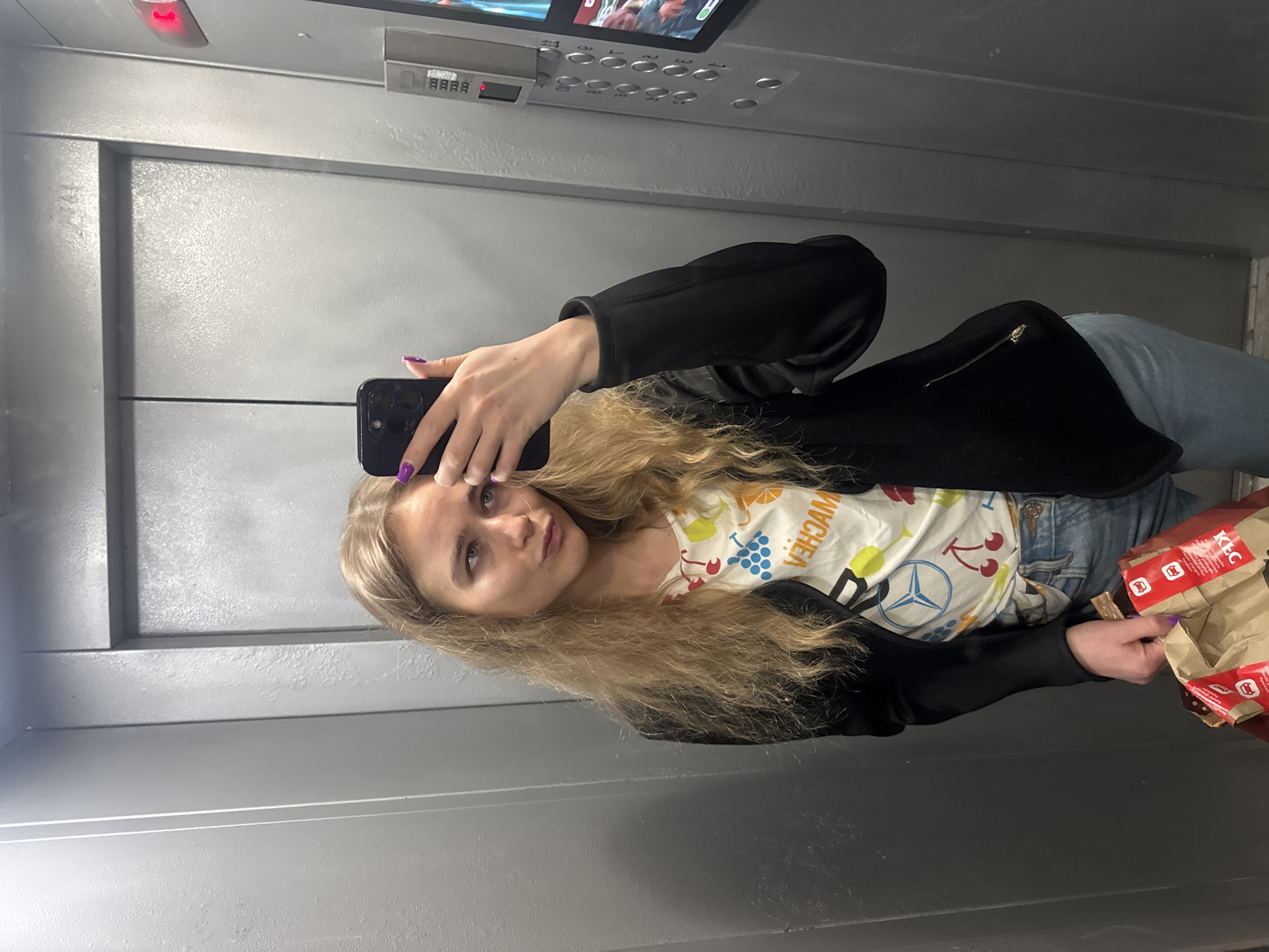 Woman Takes Elevator Selfies While Holding Fast Food Bag