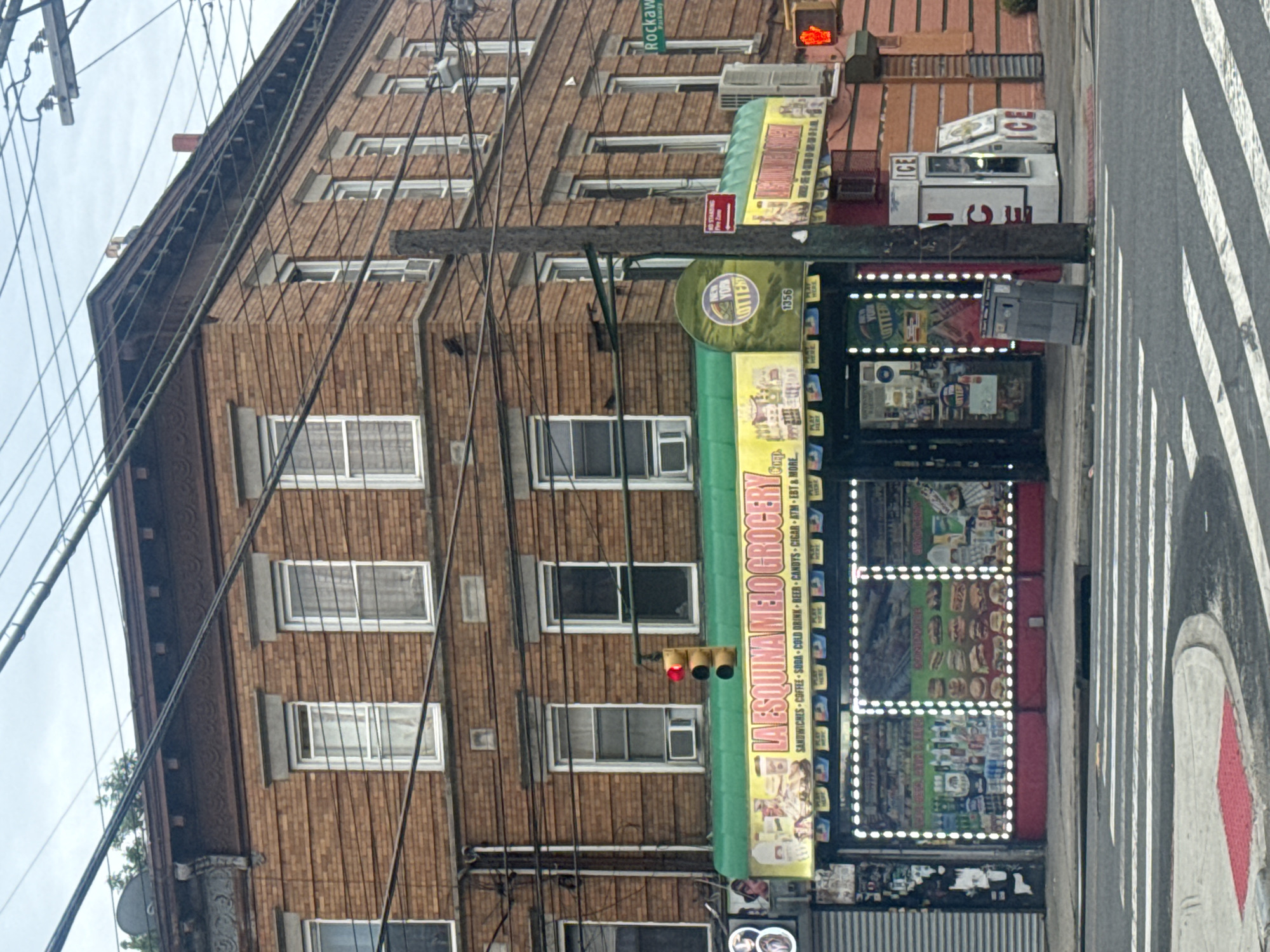 Quiet corner of Queens: bodegas, red lights, overcast morning