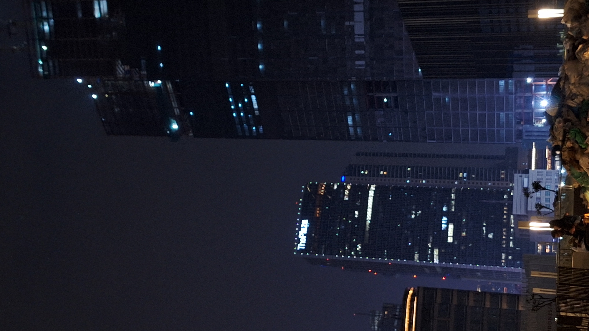 Jakarta skyline illuminated at night with ThePlaza building visible