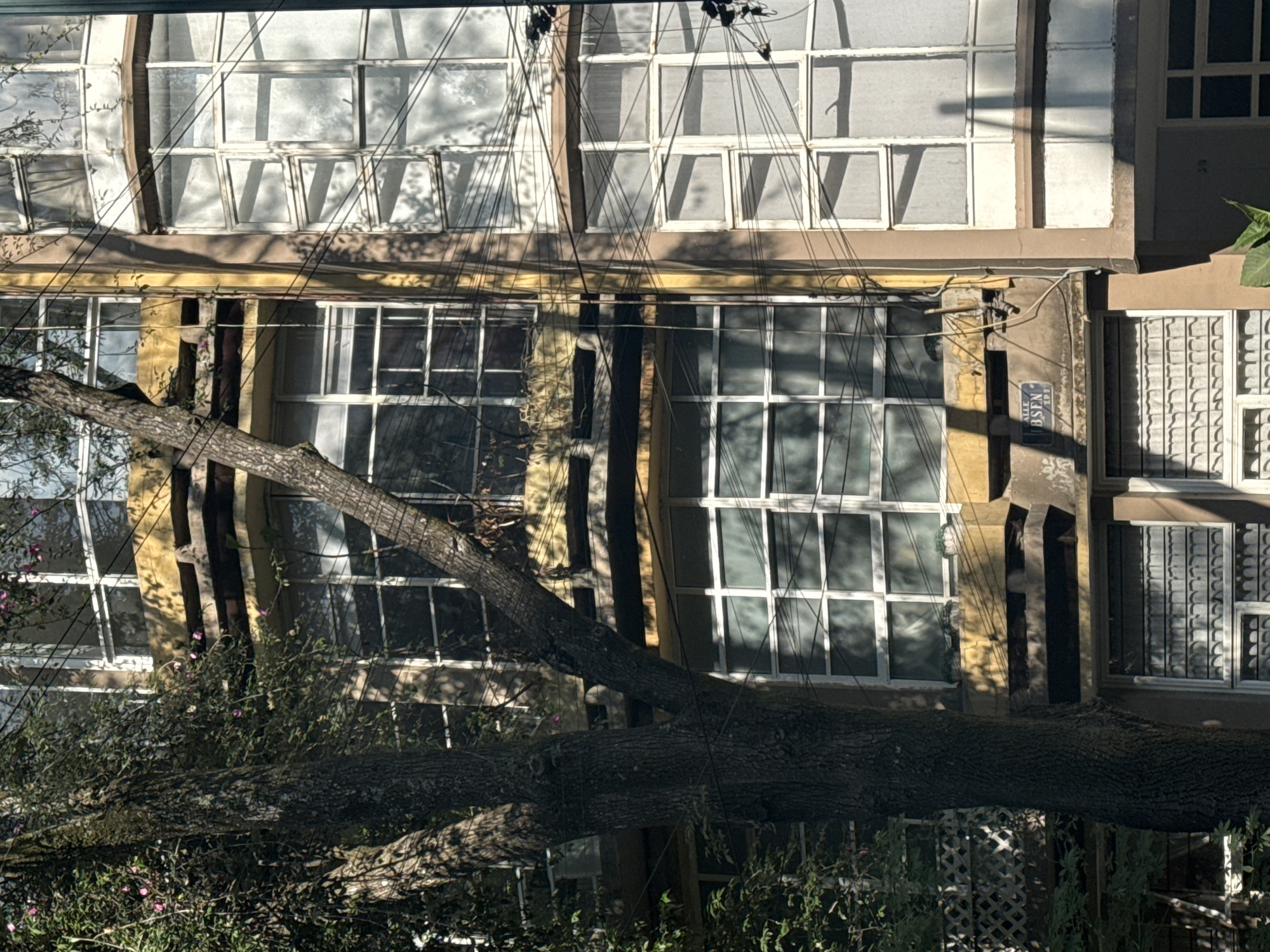 Residential buildings observed with laundry, vegetation, parked vehicle
