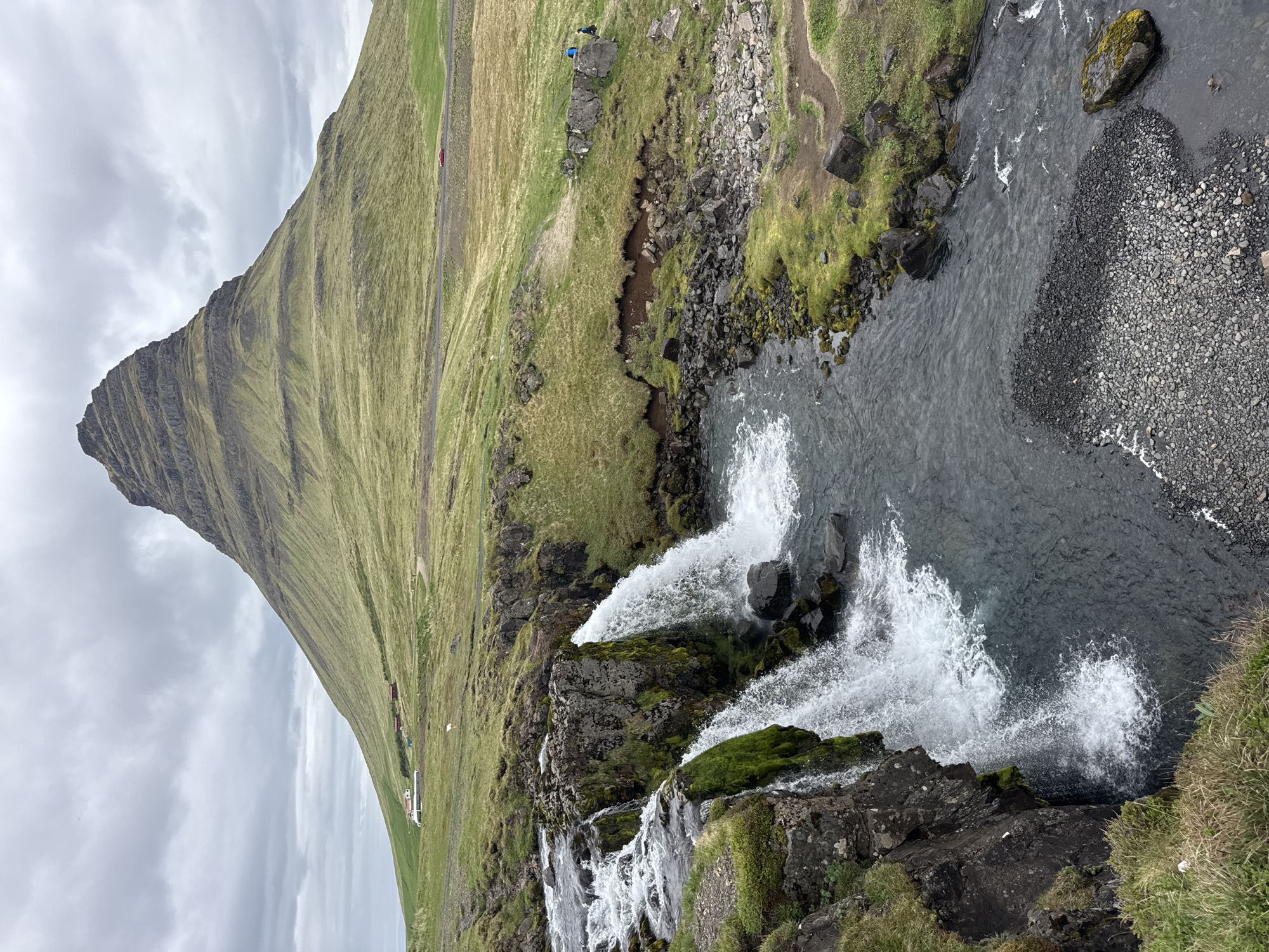 Visitors document iconic Kirkjufell mountain and waterfalls in Iceland