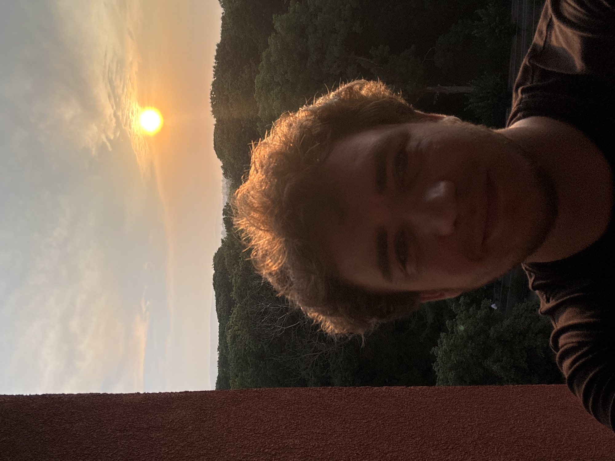 Golden-hour sunset over forested hills in Kolomyia, Ukraine