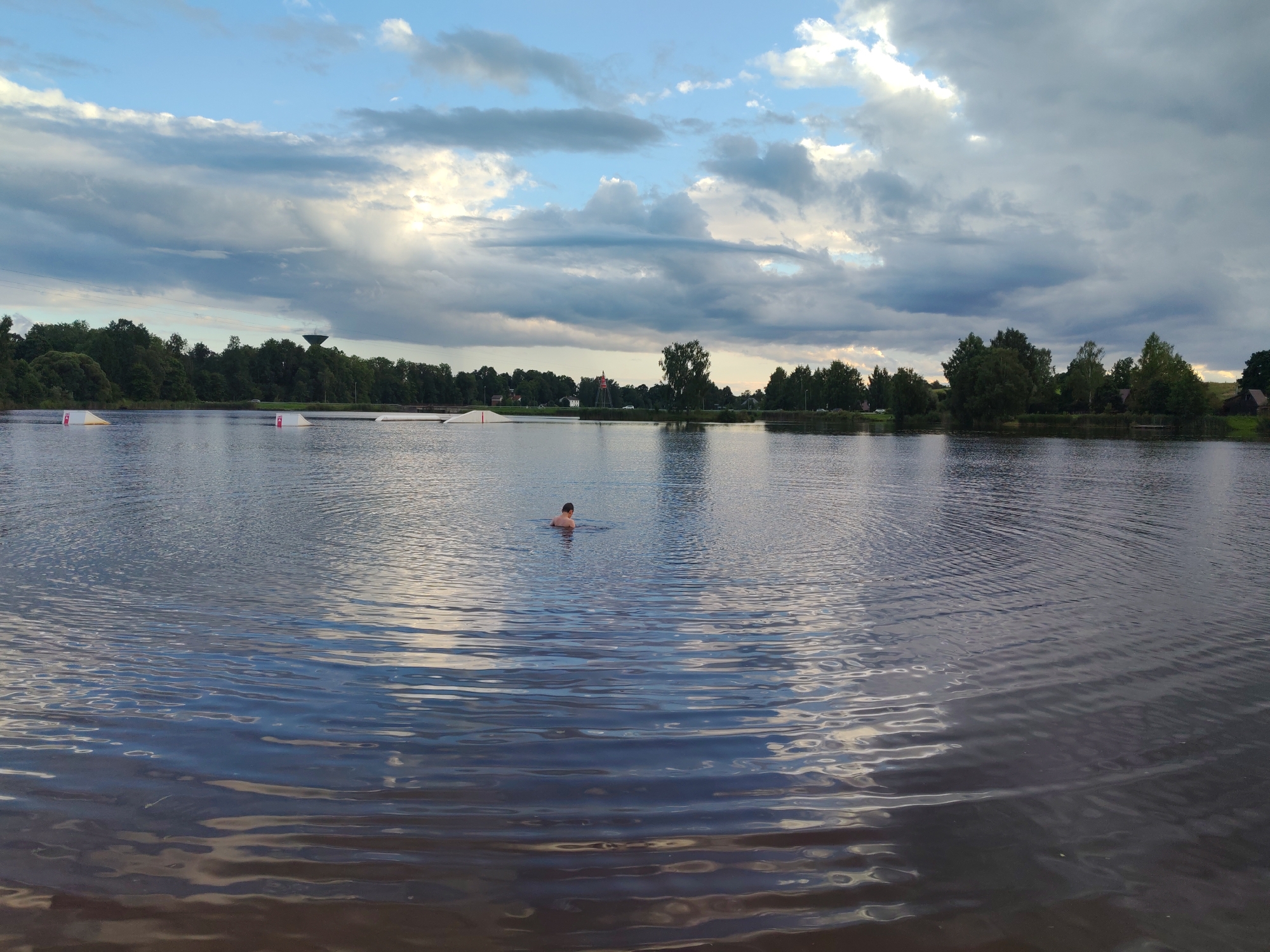 Lakeside obstacle course under a moody summer sky