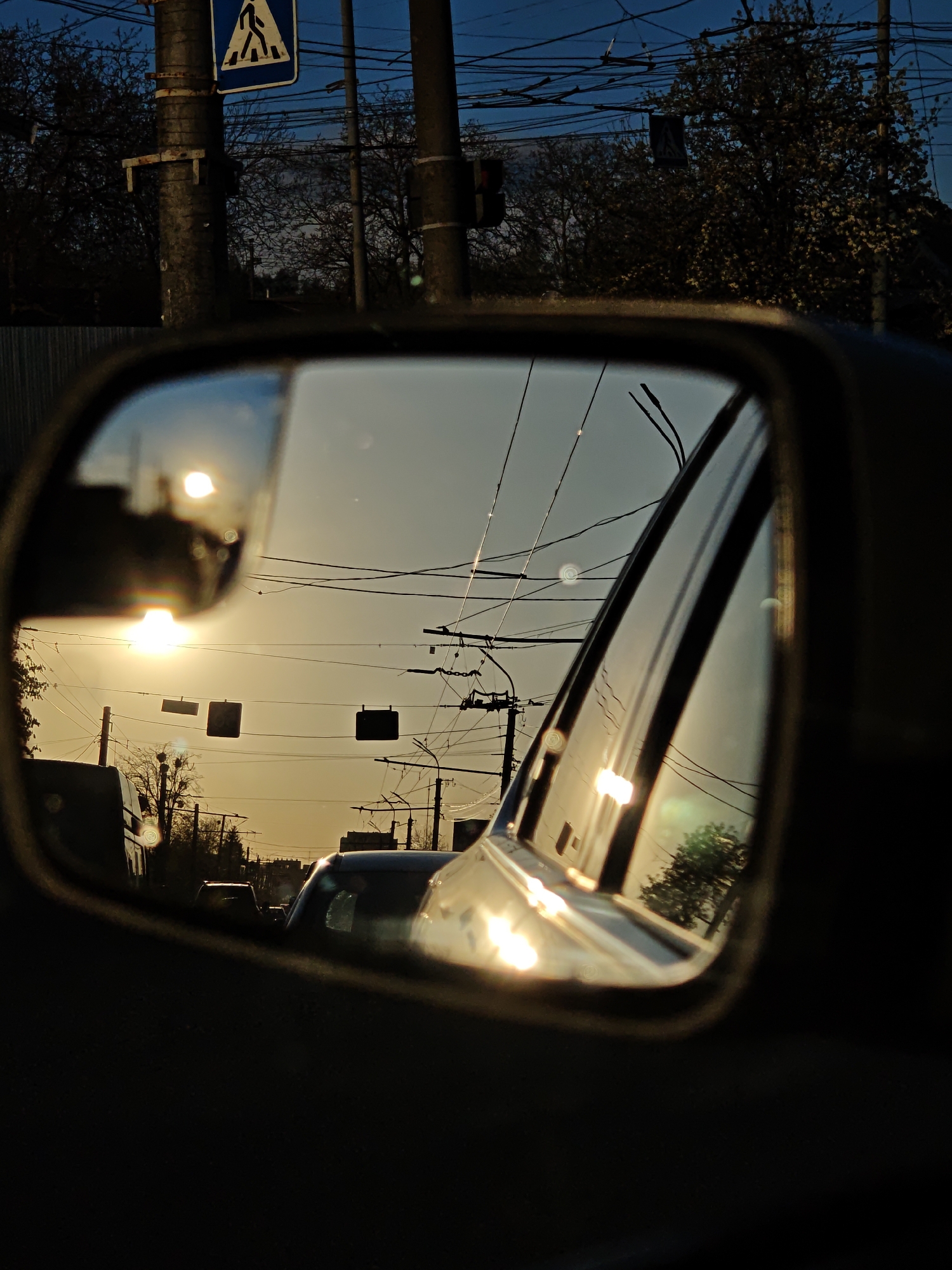 Sunset reflected in car mirror captured in Vinnytsia, Ukraine