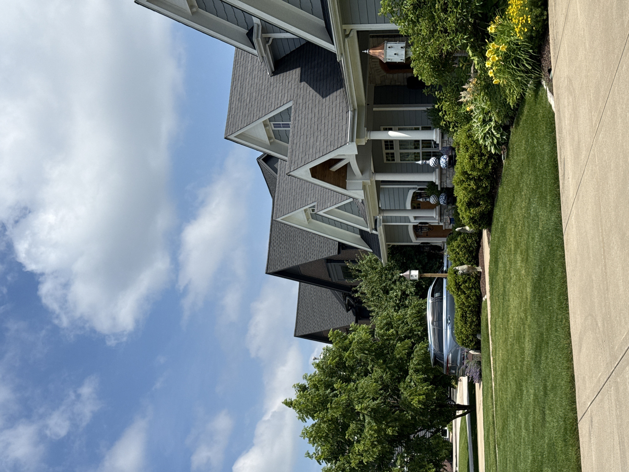 Multi-story home with blue siding and gabled dormers in Naperville